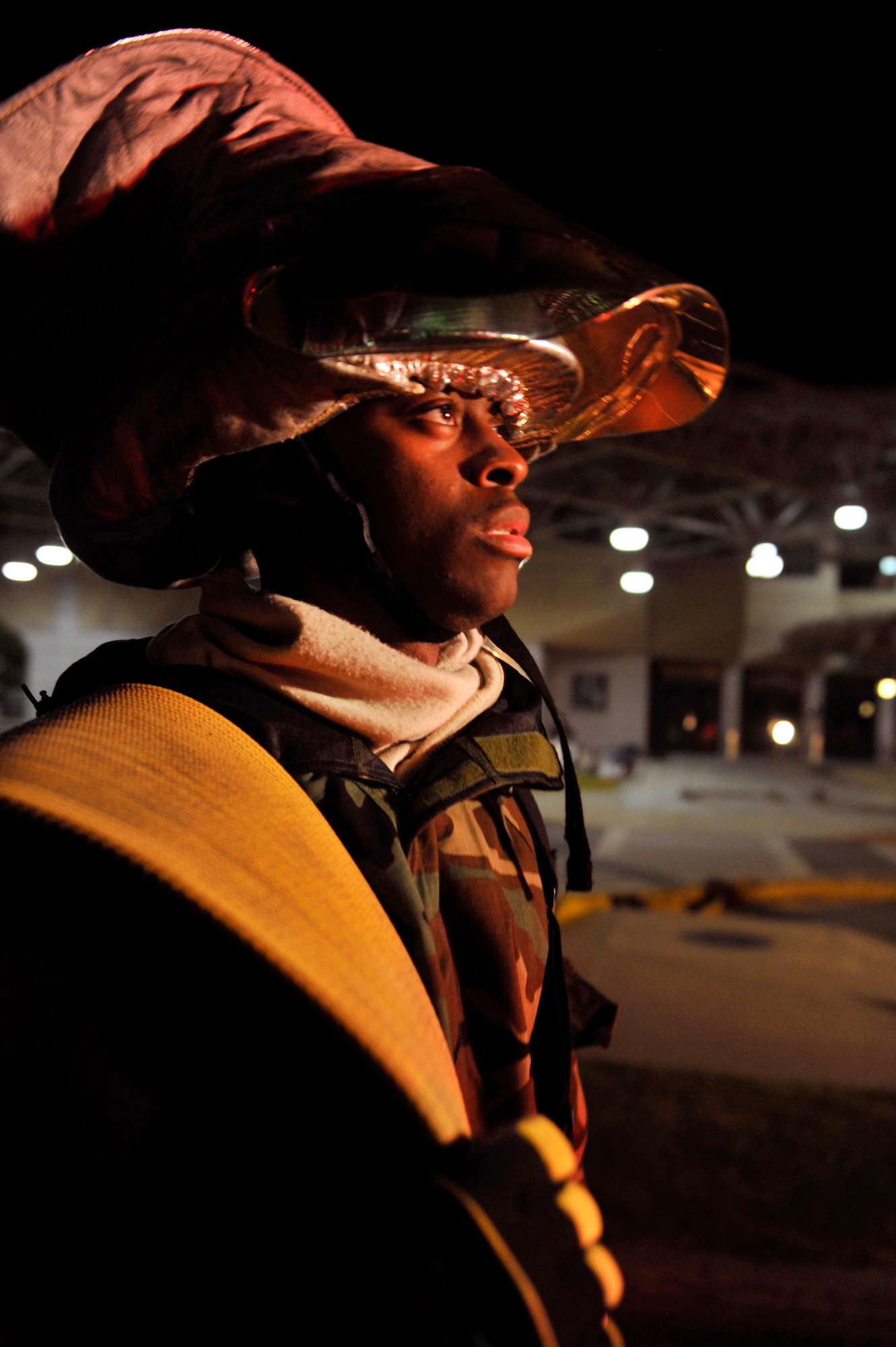 Senior Airman John Duncan, 51st Civil Engineer Squadron, holds onto the hose as firefighters place it onto the fire truck May 6 after completing a simulated missile attack scenario at the base passenger terminal on Osan Air Base, Republic of Korea. The scenario caused a fire in the building and turned into a mass casualty event. (U.S. Air Force photo by Senior Airman David Owsianka) 