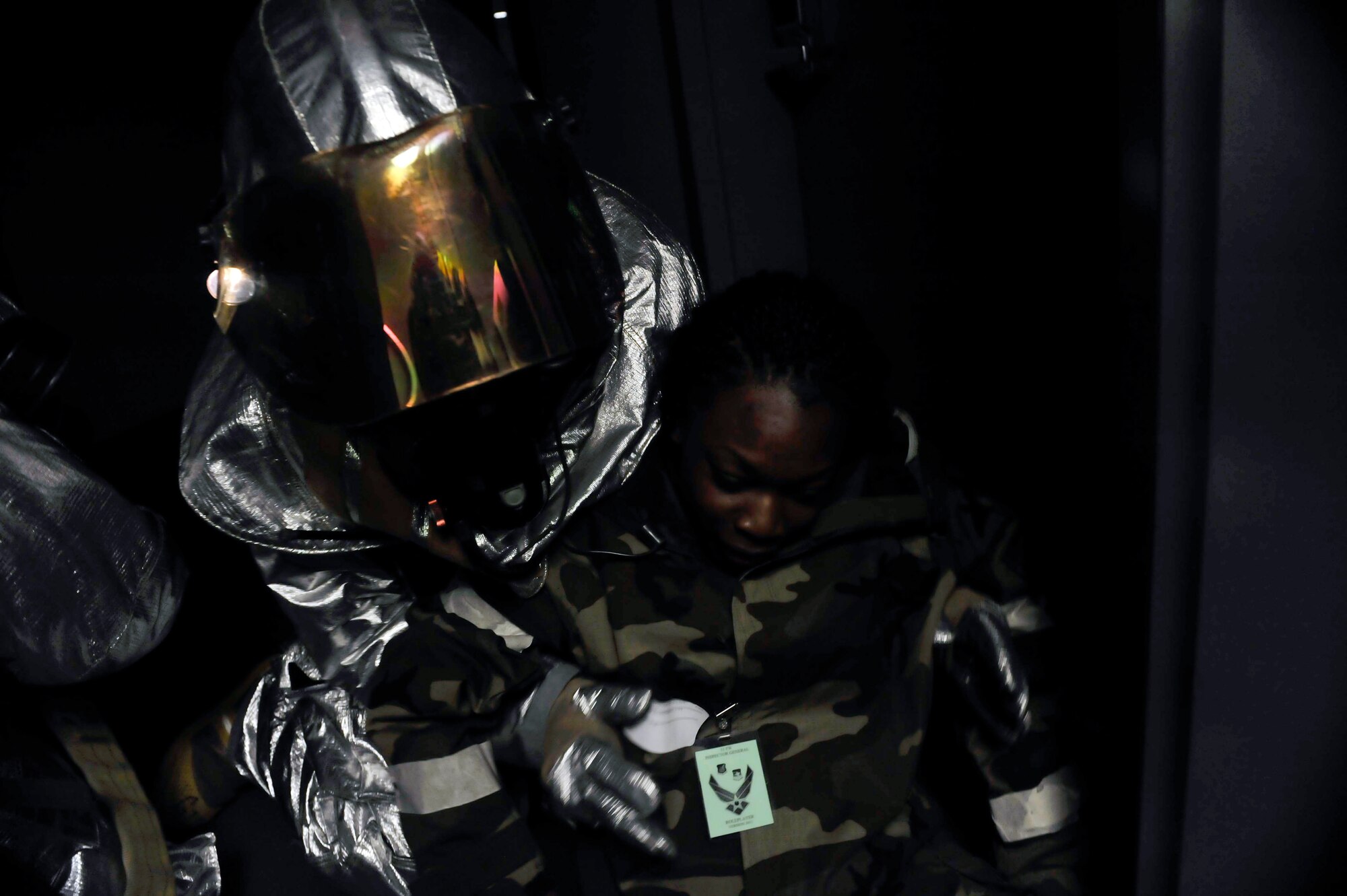 A firefighter rescues an injured Airman from inside the base passenger terminal May 6 during a simulated missile attack scenario on Osan Air Base, Republic of Korea. The scenario caused a fire in the building and turned into a mass casualty event. (U.S. Air Force photo by Senior Airman David Owsianka)