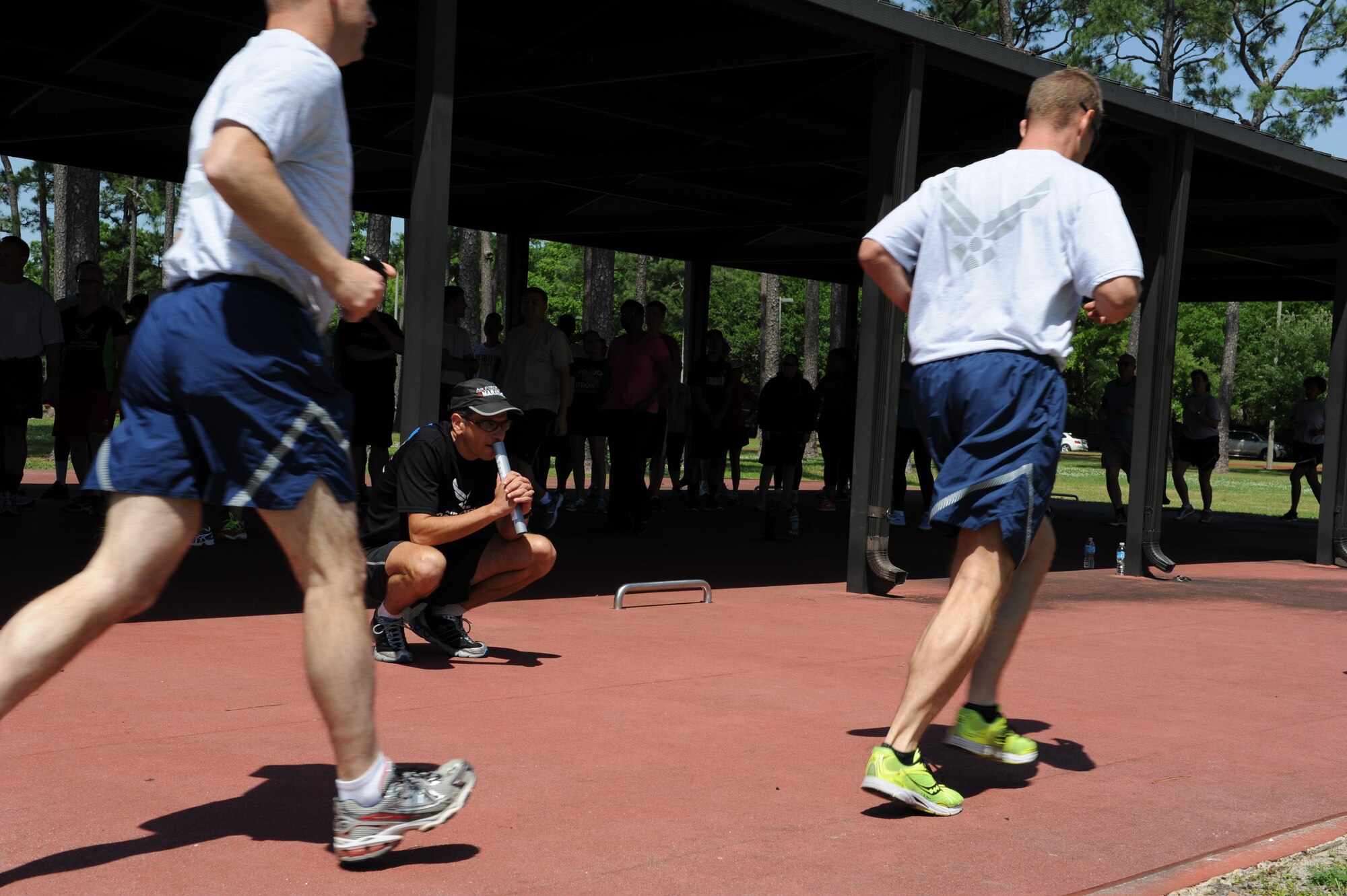 Lt. Col. (Dr.) Antonio Eppolito, chief of Air Force telemedicine, watches members of Team Keesler during a running clinic May 1, at the Crotwell Track, Keesler Air Foce base, Miss. The 81st Aerospace Medicine Squadron health and wellness center hosted the hands-on workshop with Eppolito, a 19-year member of the Air Force Running Team, as the subject matter expert. (U.S. Air Force photo by Airman 1st Class Stephan Coleman)
