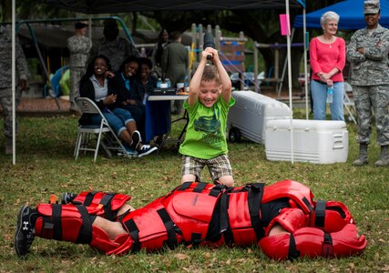 Thomas Waldbillig, son of Staff Sgt. Brian Waldbillig, 437th Maintenance Squadron hydraulics journeyman, participates in a 628th Security Forces Squadron Raven demonstration May 2, 2014, at the Joint Base Charleston Picnic. The picnic was a free two-day event which included food, drinks and a live band for all Team Charleston members and their families to enjoy. (U.S. Air Force photo/ Senior Airman Dennis Sloan)