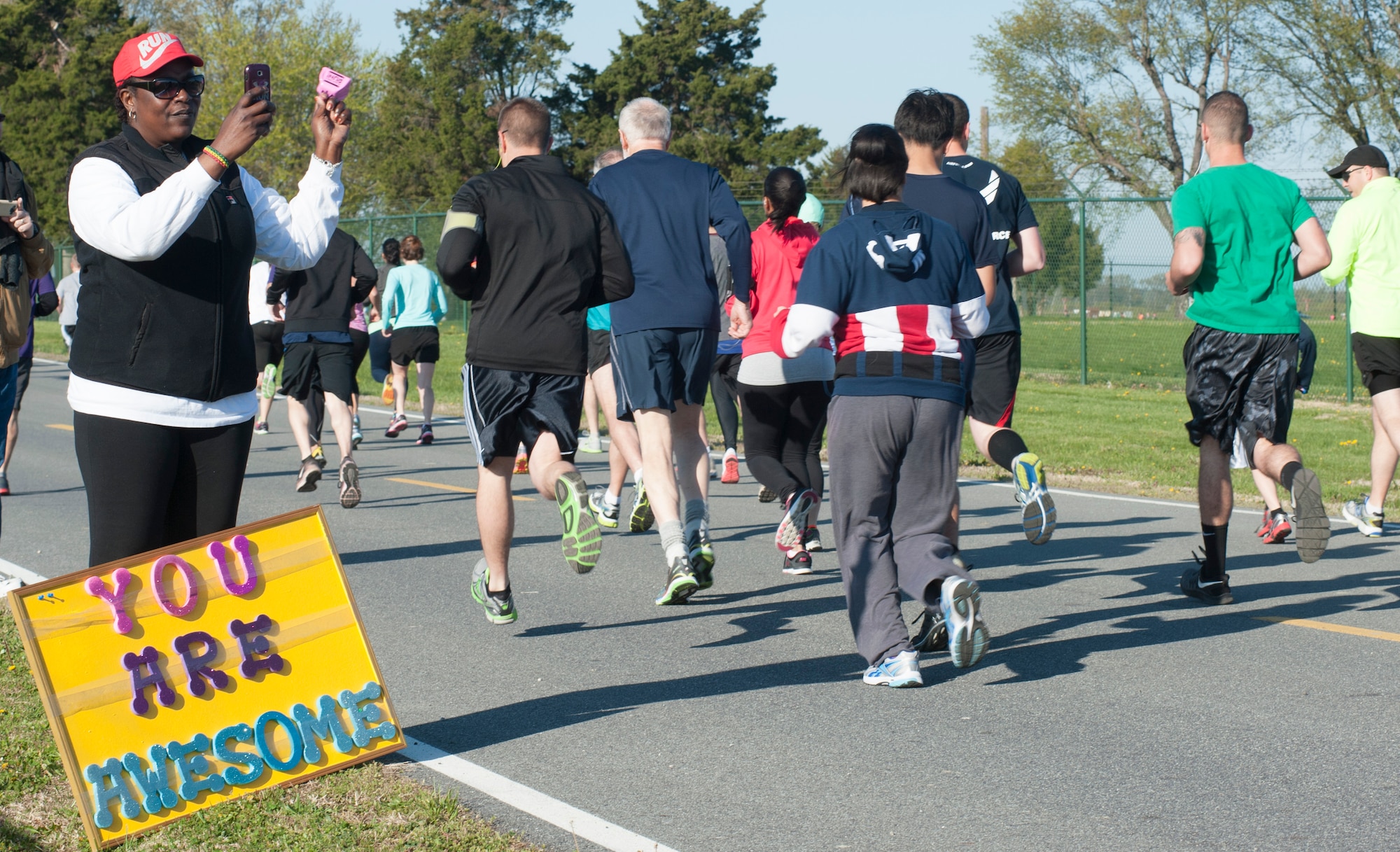 Donna Hosang cheers on her friends who are running in the Heritage Half-Marathon and 5K April 27, 2014, at the Air Mobility Command Museum on Dover Air Force Base, Del. Hosang was unable run this year, but is excited about possibly running next year. (U.S. Air Force photo/Senior Airman Jared Duhon) 
