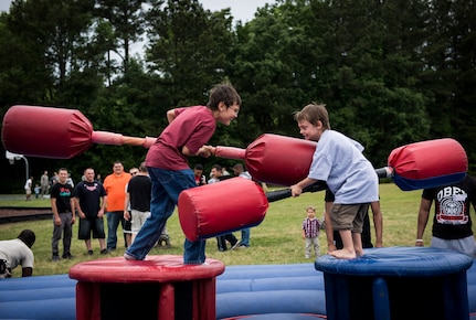 Children participate in a pugil stick battle May 2, 2014, at the Joint Base Charleston picnic. The picnic was a free two-day event which included food, drinks and a live band for all Team Charleston members and their families to enjoy. (U.S. Air Force photo/ Senior Airman Dennis Sloan)