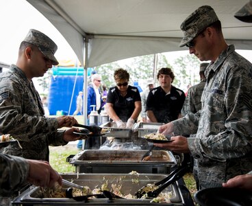 Members of Joint Base Charleston and their families enjoy a free lunch May 2, 2014, at the Joint Base Charleston picnic. The picnic was a free, two-day event which included arts and crafts as well as slides and obstacle courses. (U.S. Air Force photo/ Senior Airman Dennis Sloan)