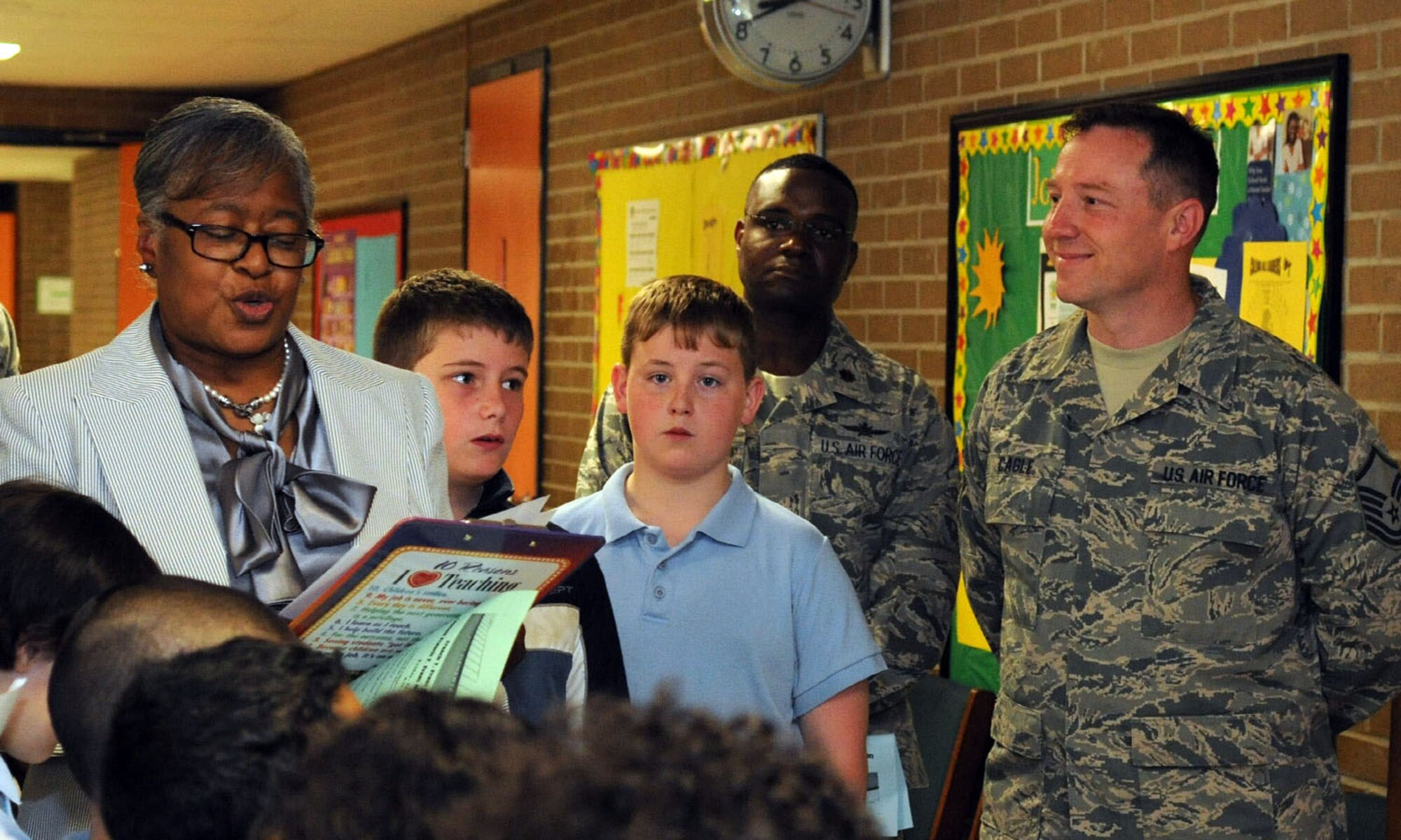 Dr. Deborah Stone, Francis T. Evans Elementary School principal, thanks members of the 844th Communications Group and 744th Communication Squadron for a memorial display case they built in honor of the school's namesake during a dedication ceremony May 2, 2014. The case displays memorabilia of Capt. Francis T. Evans, Jr. and is located at the school just outside of Joint Base Andrews, Md. (U.S. Air Force photo/Aimee Fujikawa)