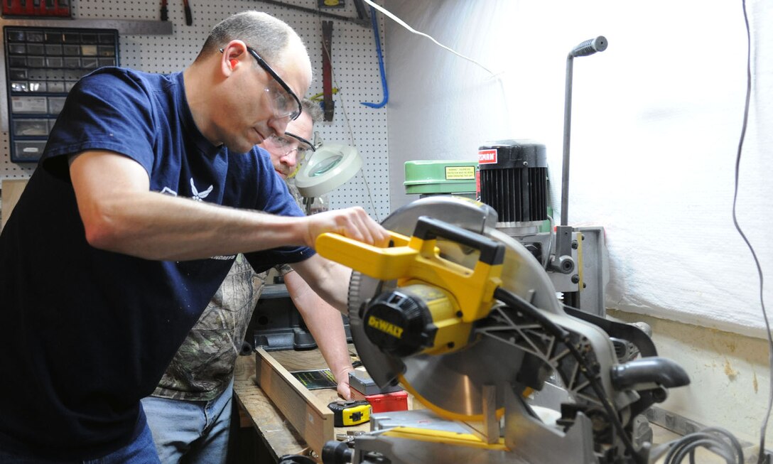 Master Sgts. Phillip Allen and Matt Cagle, 744th Communication Squadron plans and program managers, begin constructing a memorial display case at Cagle’s home workshop in Clinton, Md., April 22, 2014. The case displays memorabilia of the school’s namesake, Capt. Francis T. Evans, Jr. and is located at the school just outside of Joint Base Andrews, Md. (U.S. Air Force photo/Aimee Fujikawa)