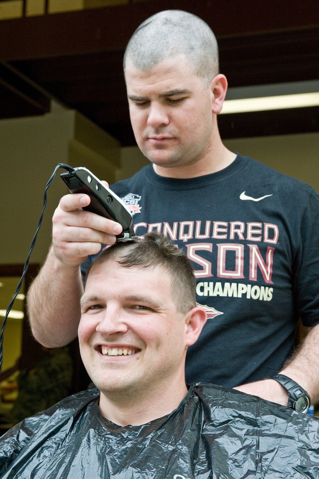 1st Lt. Robert Rice, 4th Security Forces Squadron operations officer, shaves the head of Tech. Sgt. Gary Little, 4th SFS unit trainer, to raise money for a 4th SFS member’s family, May 2, 2014, at Seymour Johnson Air Force Base, N.C. More than thirty volunteers’ heads were shaved to support their fellow security forces member facing an unexpected hardship. (U.S. Air Force photo/Airman 1st Class Aaron J. Jenne)