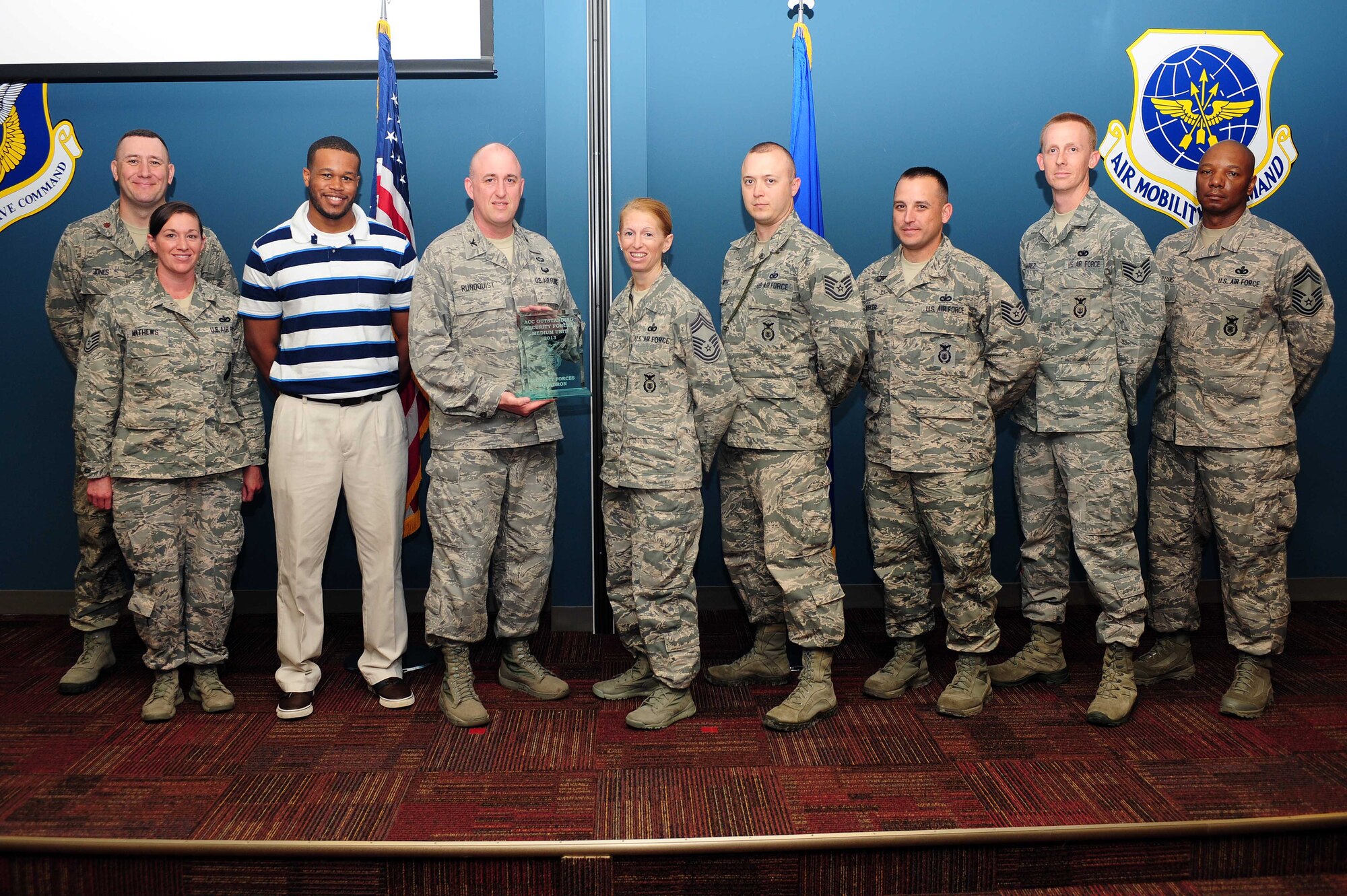 Col. Erik Rundquist, Director of Security Forces, Headquarters Air Combat Command, presents the ACC Outstanding Medium Security Forces Unit award to the 4th Security Forces Squadron, April 30, 2014, at Seymour Johnson Air Force Base, N.C. Rundquist visited the 4th SFS to observe first-hand operations and procedures the Airmen perform daily and to give the squadron the award. (U.S. Air Force photo/Senior Airman John Nieves Camacho)