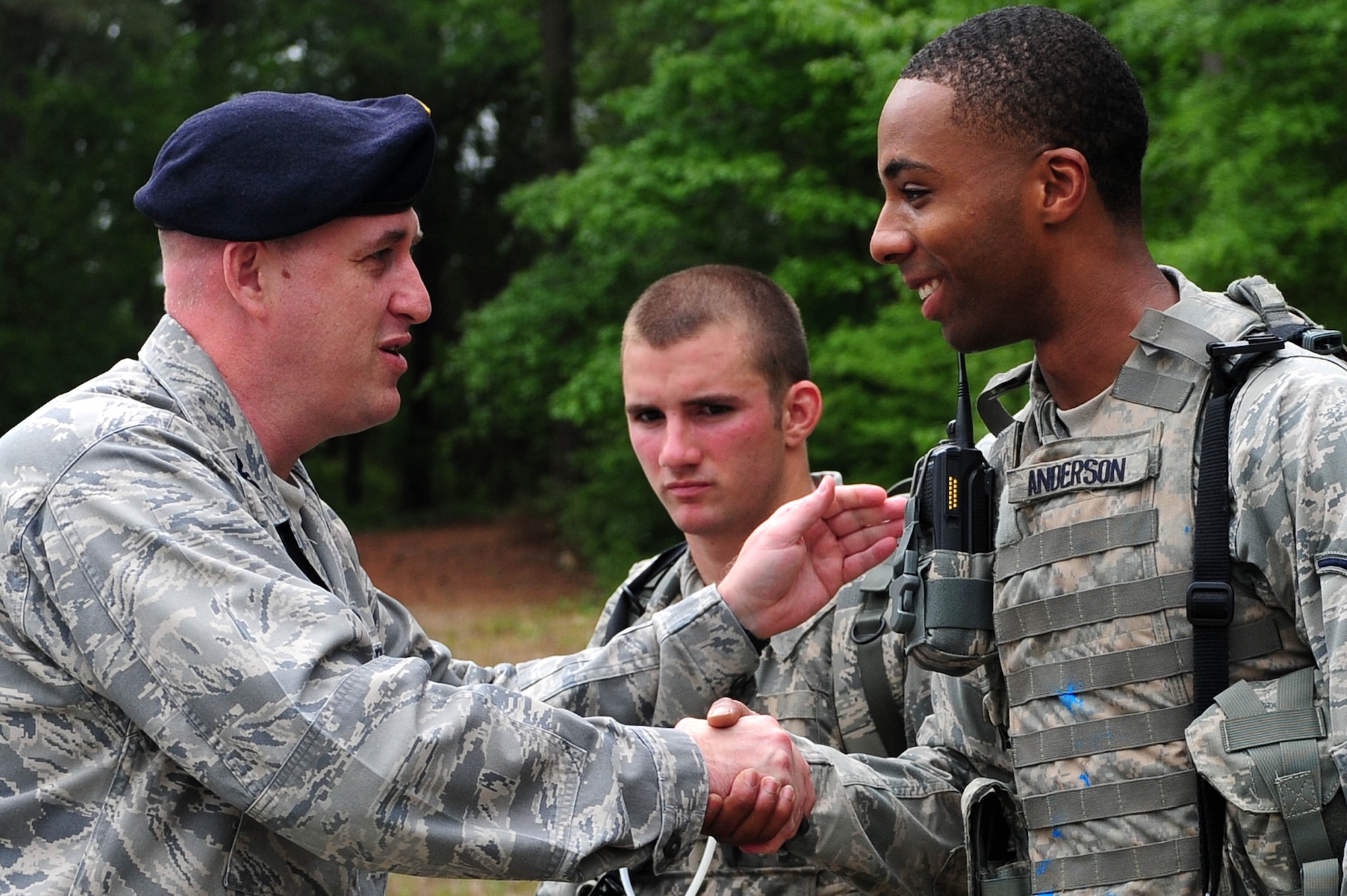 Col. Erik Rundquist, Director of Security Forces, Headquarters Air Combat Command, praises Airman Gary Anderson, 4th Security Forces Squadron patrolman, for good work after an exercise, April 29, 2014, at Seymour Johnson Air Force Base, N.C. Rundquist visited the 4th SFS to observe first-hand operations and procedures the Airmen perform daily and to give the squadron the ACC Outstanding Medium Security Forces Unit award. (U.S. Air Force photo/Senior Airman John Nieves Camacho) 