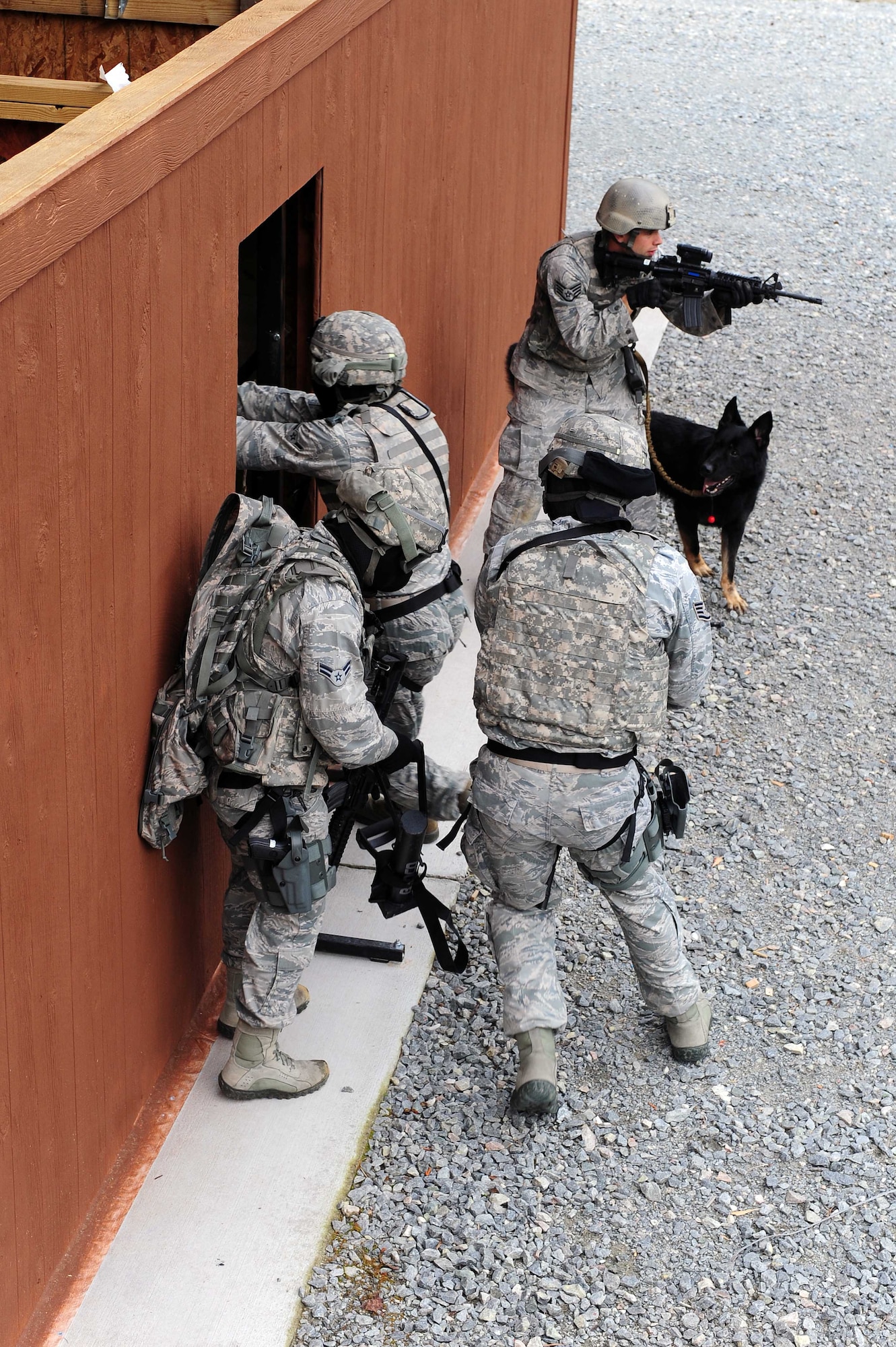 Airmen from the 4th Security Forces Squadron breach a building during an exercise, April 29, 2014, at Seymour Johnson Air Force Base, N.C. Col. Erik Rundquist, Director of Security Forces, Headquarters Air Combat Command, visited the 4th SFS recently, to view their combat readiness and daily operations. (U.S. Air Force photo/Senior Airman John Nieves Camacho)