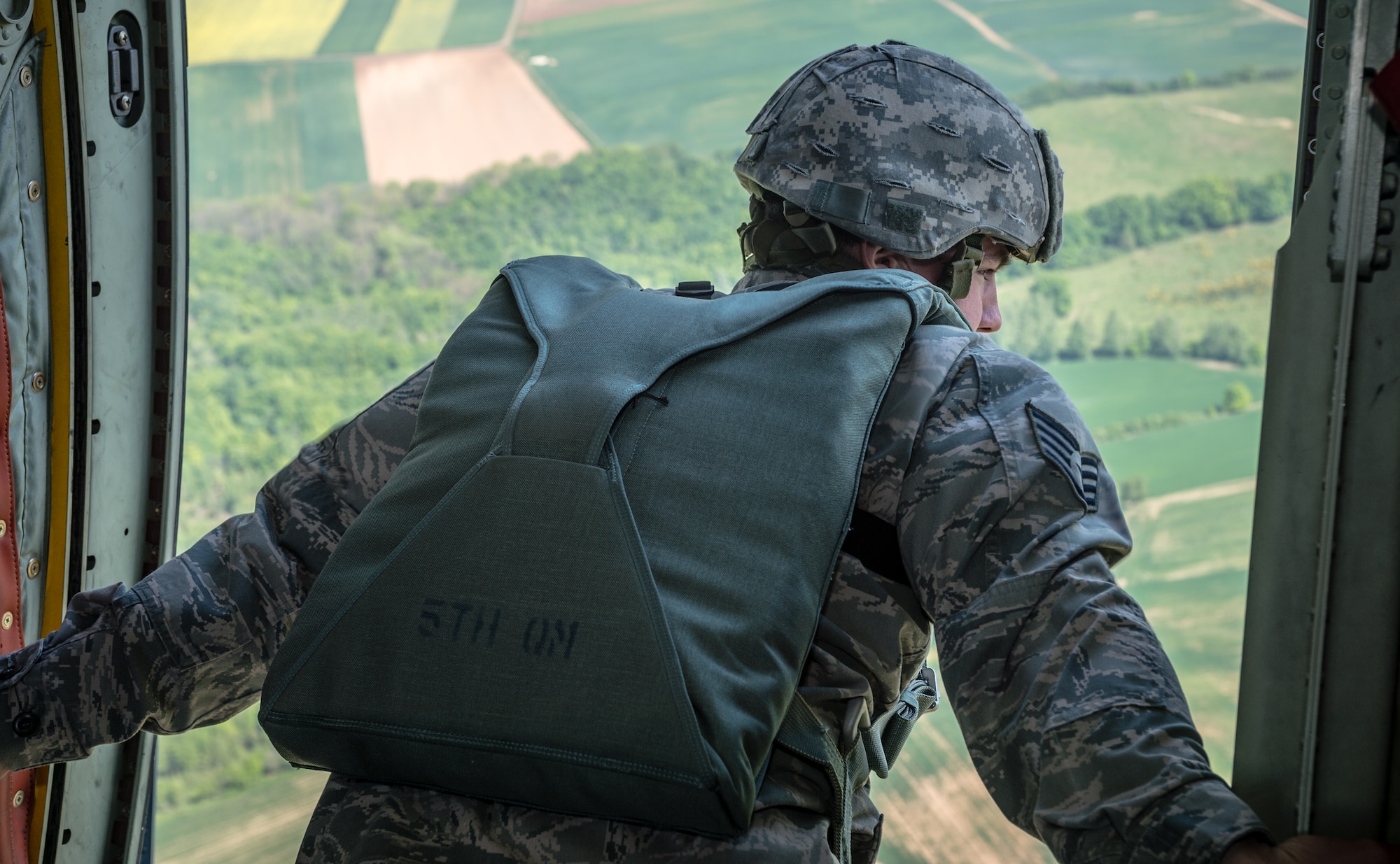 U.S. Air Force Staff Sgt. Jonathan Smith, 435th Security Forces Squadron jumpmaster, scans a landing zone in preparation for aerial disembarkments inside a C-130J Super Hercules as part of International Jump Week over Germany May 5, 2014. A total of 97 foreign and allied partners tested, built and strengthened partnerships during jump week alongside American Airmen and Soldiers. (U.S. Air Force photo/Airman 1st Class Jordan Castelan)