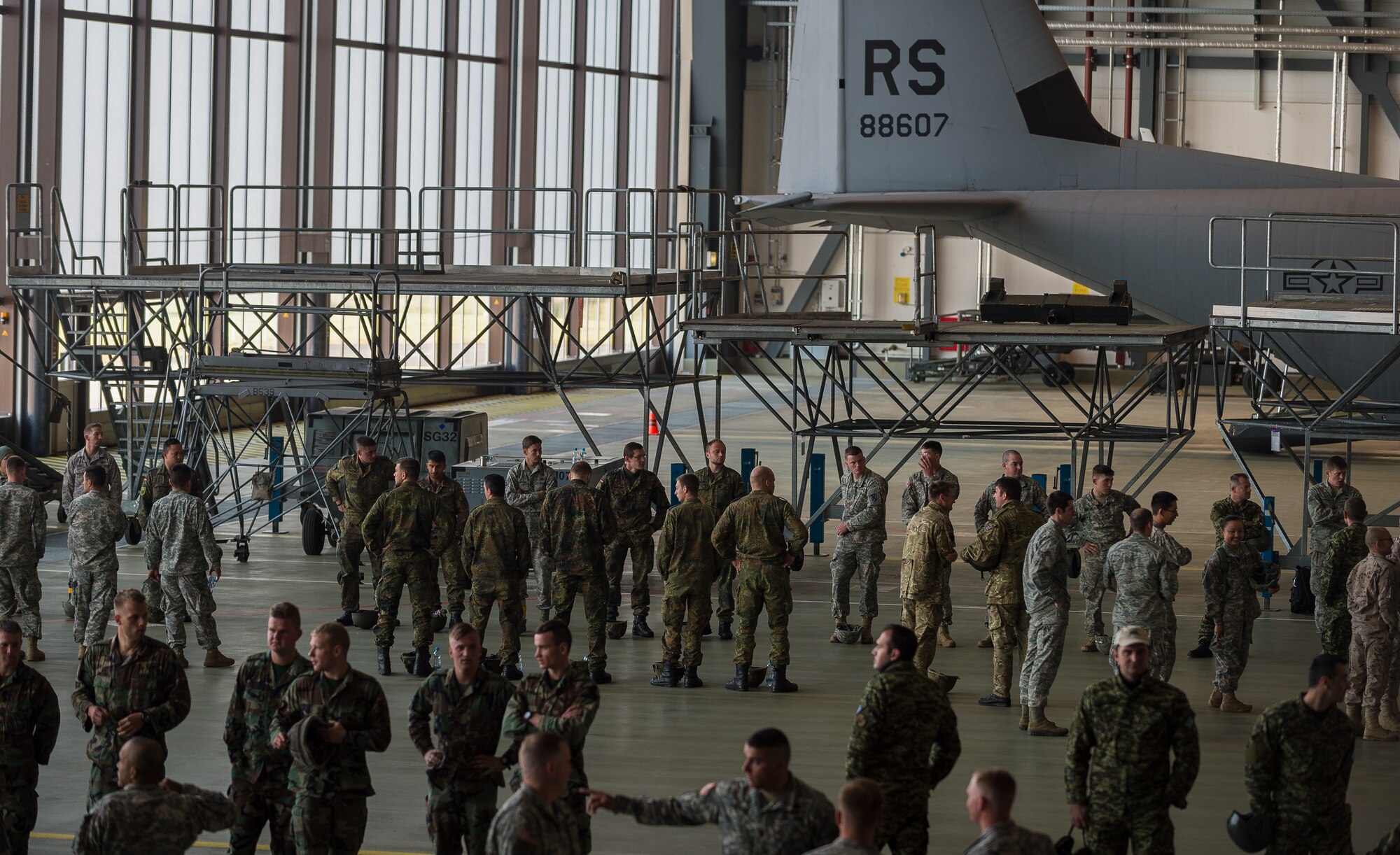 American Service Member parachutists, and parachutists from eight visiting countries, prepare to board a C-130J Super Hercules as part of International Jump Week on Ramstein Air Base, Germany, May 5, 2014. A total of 97 foreign and allied partners tested, built and strengthened partnerships during jump week alongside American Airmen and Soldiers. (U.S. Air Force photo/Airman 1st Class Jordan Castelan)