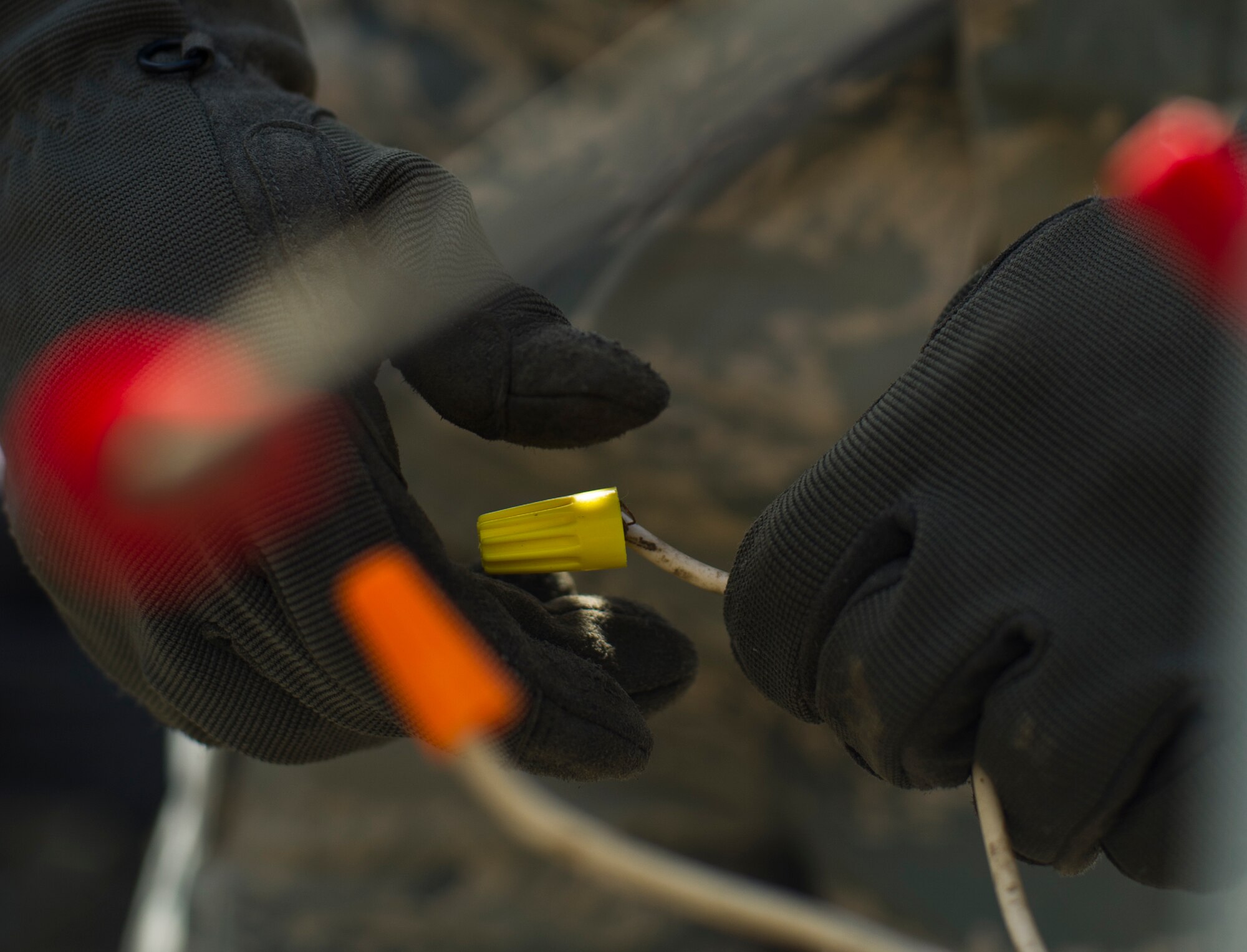Airman Adam Fiktus, 5th Civil Engineer Squadron electrical systems apprentice, fixes an electrical outlet box at Minot Air Force Base, N.D., April 24, 2014. Electricity is a fundamental utility that allows command centers and Airmen to successfully fulfill their missions. Installing, repairing and maintaining this electrical network is the job of the electrical systems specialists. (U.S. Air Force photo/Senior Airman Brittany Y. Auld)
