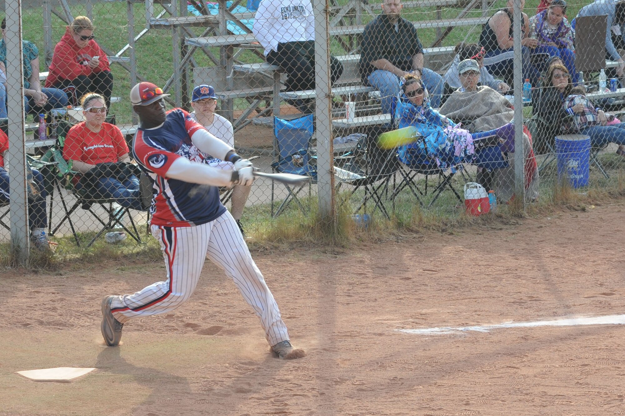 A Saber Nation softball player hits a ball during the fourth annual Cinco De Mayo softball tournament May 4, 2014 at Spangdahlem Air Base, Germany.  This is the second of eight tournaments throughout the year the team will play in. (U.S. Air Force photo by Airman 1st Class Dylan Nuckolls/Released)