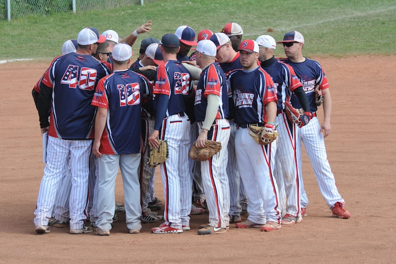 The Saber Nation softball team holds a meeting on the pitcher’s mound after a game during the fourth annual Cinco De Mayo softball tournament May 4, 2014 at Spangdahlem Air Base, Germany.  A total of 16 teams from all over Europe participated in the tournament. (U.S. Air Force photo by Airman 1st Class Dylan Nuckolls/Released)