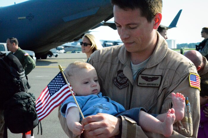 1st Lt. Matthew Grossey, 17th Airlift Squadron, holds his son after returning from a two-month deployment to Southwest Asia, May 3, 2014, at Joint Base Charleston, S.C. During their two-month deployment to Southwest Asia, the squadron completed more than 800 sorties, logged in 2,381 flying hours and airlifted more than 28.5 million pounds of cargo and approximately 18,700 passengers. (U.S. Air Force photo/Staff Sgt. AJ Hyatt)