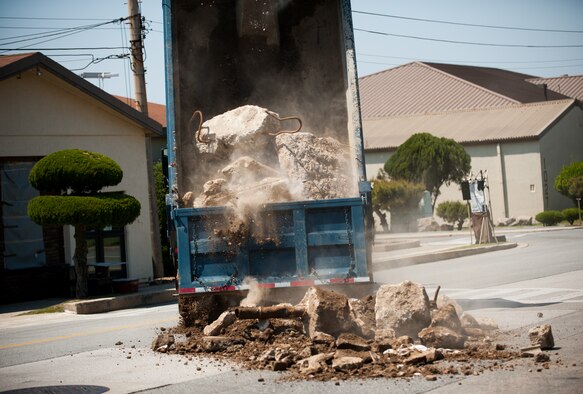Tech. Sgt. Miguel Landeros, 8th Civil Engineer Squadron housing management NCO in charge,  spreads boulders for an inject during exercise Beverly Bulldog 14-2 at Kunsan Air Base, Republic of Korea, May 6, 2014. Injects are scenarios that test the Wolf Pack's capabilities during exercises. (U.S. Air Force photo by Staff Sgt. Clayton Lenhardt/Released)