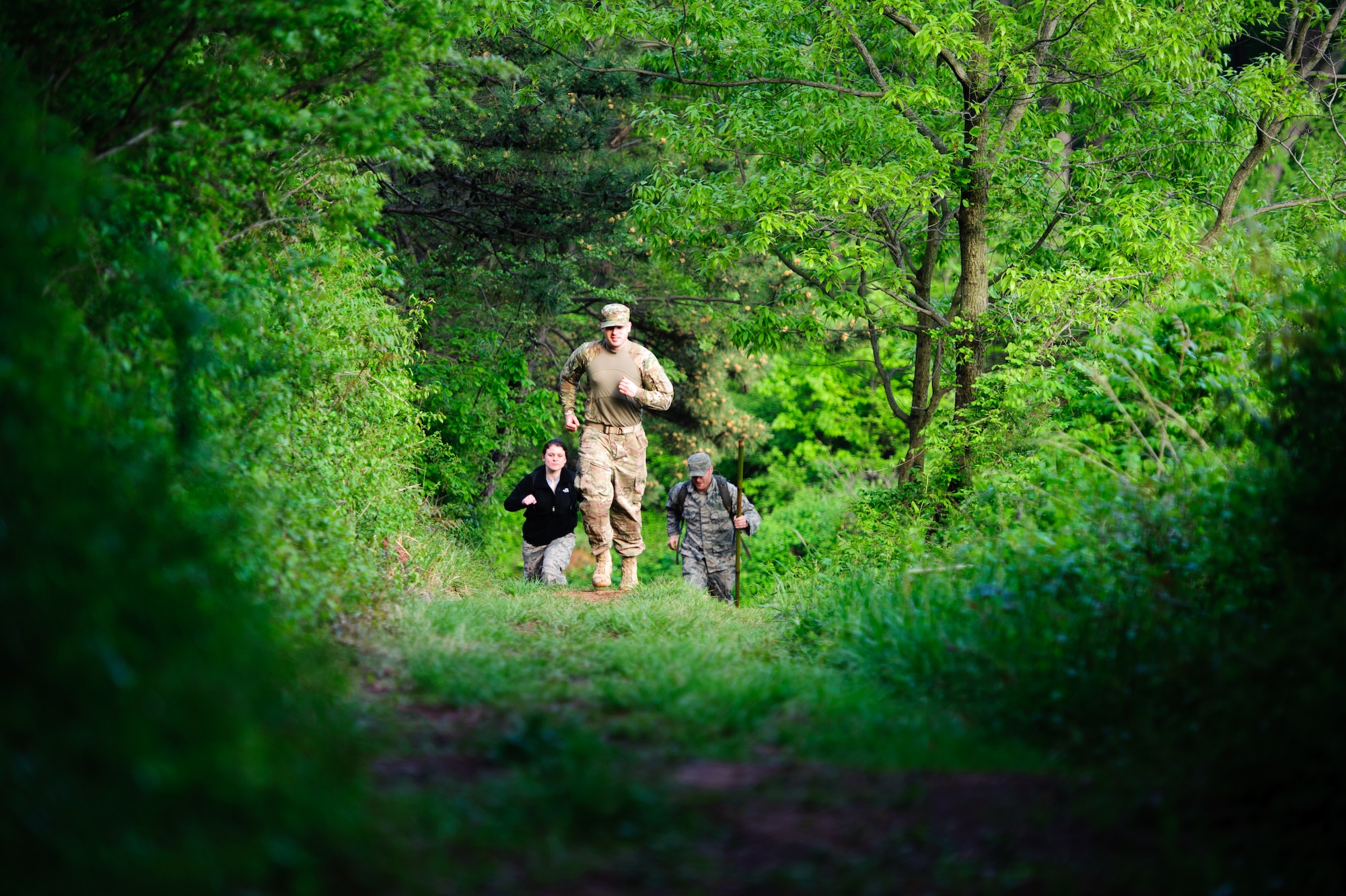 Airman 1st Class Julia Liggio, 8th Security Forces opposition force hunter, left, Senior Airman Colton Becker, 8th SFS OPFOR hunter, middle, and Staff Sgt. Charles Nelson, 8th SFS OPFOR hunter, begin to track and hunt pilots during a combat survival exercise near Kunsan Air Base, Republic of Korea, April 28, 2014. The Survival, Evasion, Resistance and Escape sections trained pilots on procedures to evade adversaries and return to friendly forces in case they need to eject. (U.S. Air Force photos by Senior Airman Armando A. Schiwer-Morales/Released)