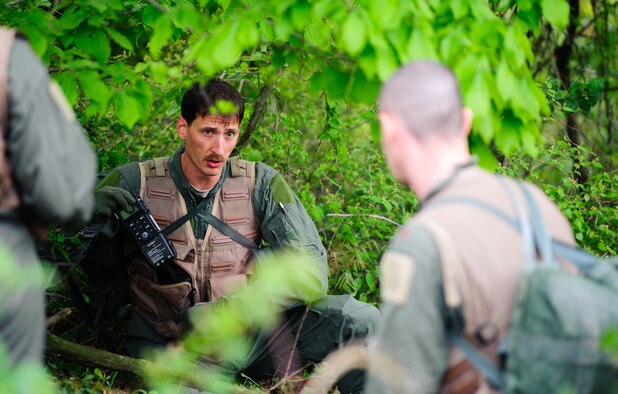 Tech. Sgt. Kurtis Douge, 8th Operations Support Squadron SERE specialist and weapons and tactics NCO in charge, explains radio procedures to pilots during their combat survival exercise near Kunsan Air Base, Republic of Korea, April 28, 2014. Douge and the Survival, Evasion, Resistance and Escape sections trained pilots on procedures to evade adversaries and return to friendly forces in case they need to eject. (U.S. Air Force photos by Senior Airman Armando A. Schiwer-Morales/Released) 