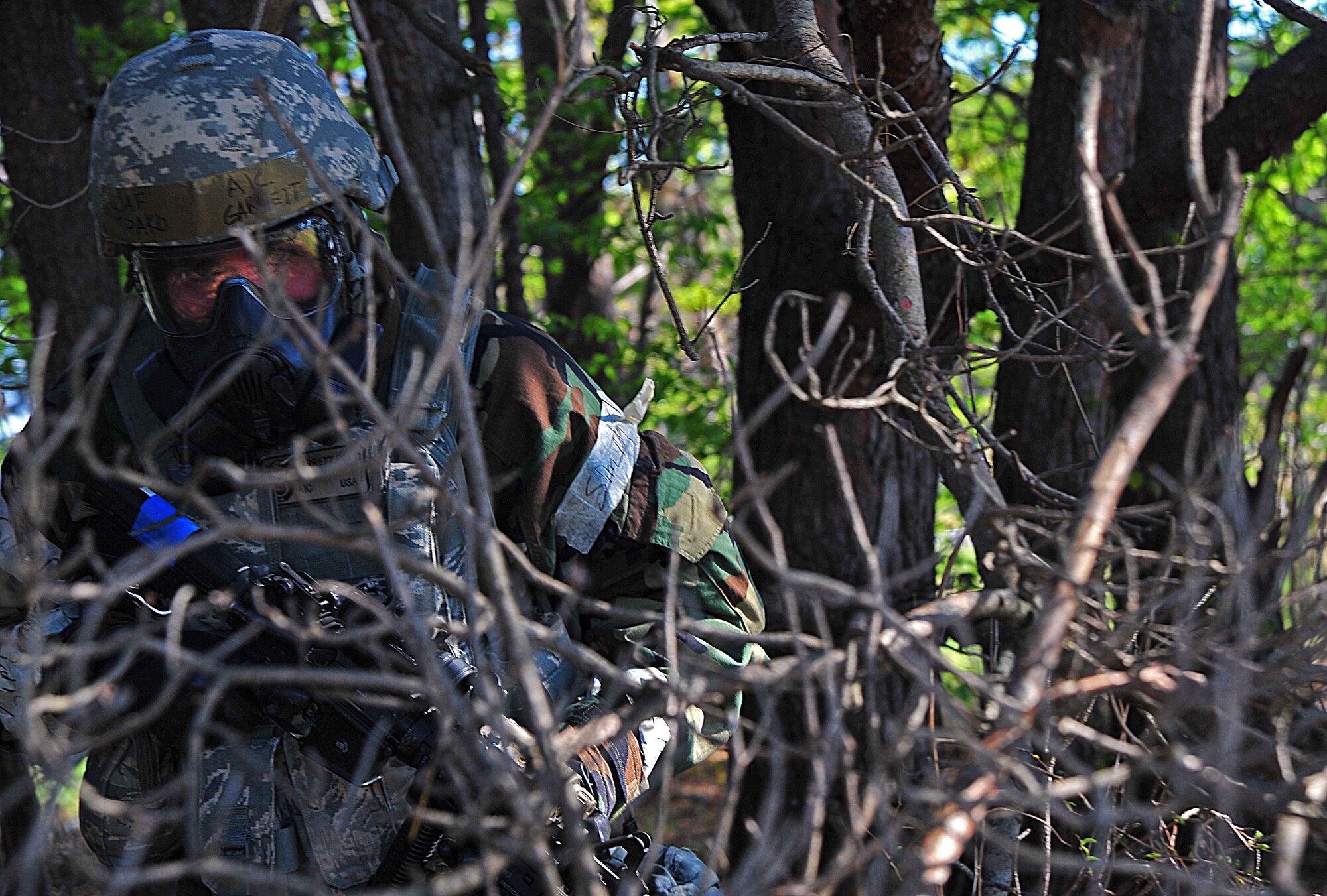 U.S. Air Force Airman 1st Class Garrett Pako, 35th Security Forces Squadron entry controller, completes a security sweep through brush following the capture of a gunman during an Operational Readiness Exercise at Misawa Air Base, Japan, May 6, 2014. Security personnel must conduct a perimeter check after neutralizing a threat to ensure safety and security of the area. (U.S. Air Force photo/Senior Airman Jose Hernandez-Domitilo)