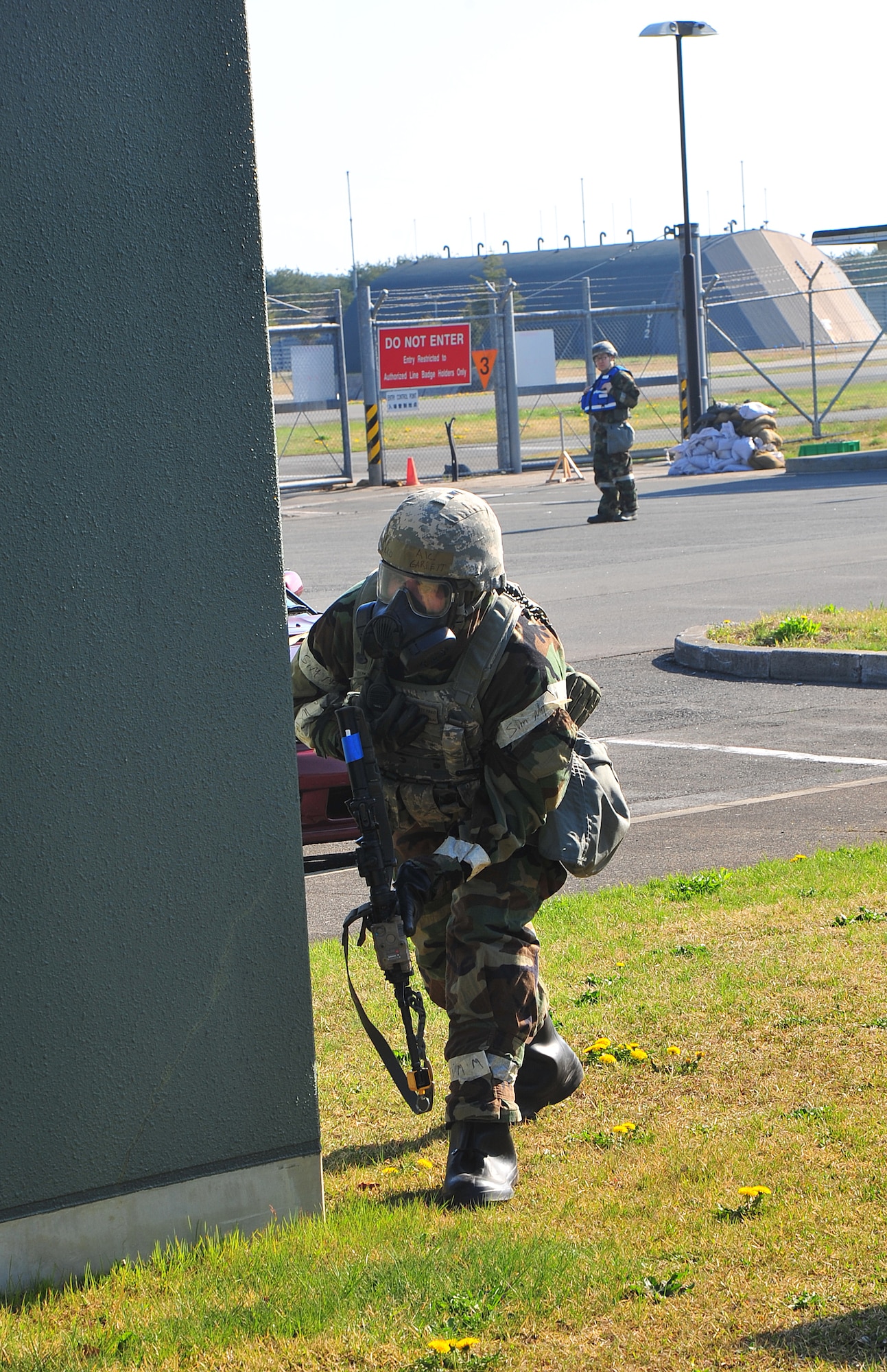 U.S. Air Force Airman 1st Class Garrett Pako, 35th Security Forces Squadron entry controller, pursues an armed assailant during a ground attack as part of an Operational Readiness Exercise at Misawa Air Base, Japan, May 6, 2014. The primary mission of entry controllers is to maintain the safety and security of the installation and its assets. (U.S. Air Force photo/Senior Airman Jose Hernandez-Domitilo)