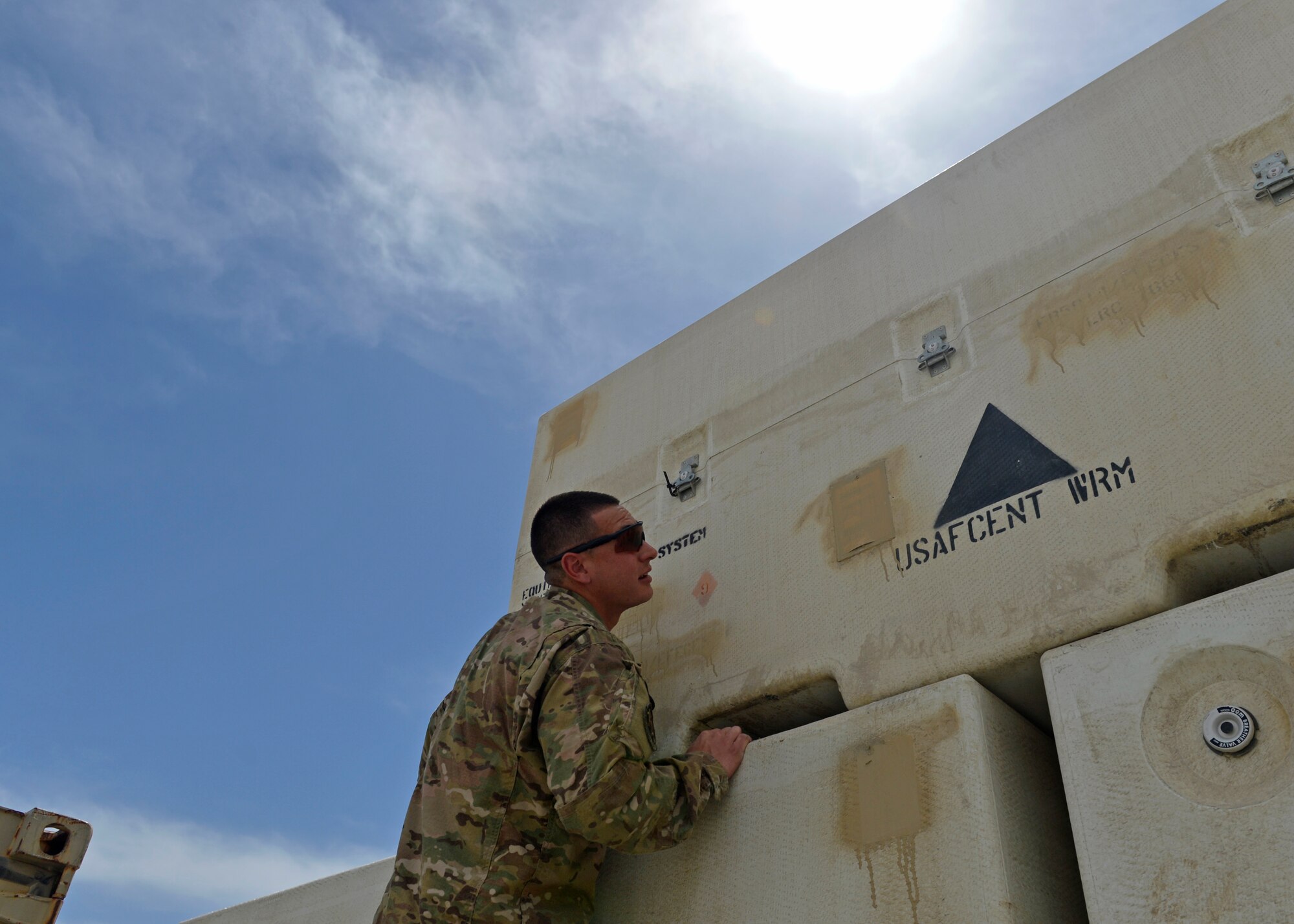 Staff Sgt. Anthony Vasquez, 455th Expeditionary Logistics Readiness Squadron day shift supervisor, identifies equipment containers May 2, 2014 at Bagram Airfield, Afghanistan. Vasquez, as part of Central Command Materiel Recovery Element helps identify, store and redeploy assets to the U.S. or disposing of items located throughout the region. The CMRE team has helped recover more than 60 pieces of equipment worth $1.66 million within the last eight months. Vasquez is a native of El Paso, Texas and is deployed from Travis Air Force Base, Calif. (U.S. Air Force by Staff Sgt. Evelyn Chavez/Released)