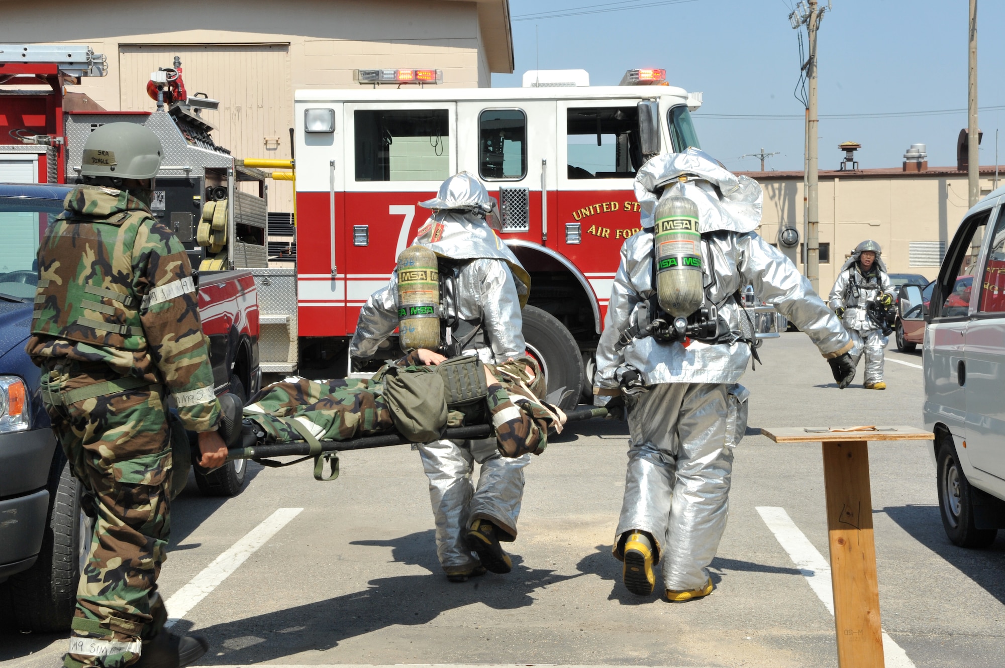 Firefighters from the 51st Civil Engineer Squadron help a member of Bldg. 938’s post-attack reconnaissance team carry a mock casualty to a casualty collection point during Operational Readiness Exercise Beverly Bulldog 14-02 at Osan Air Base, Republic of Korea, May 6, 2014. First responders assisted the building’s post-attack reconnaissance teams with the triage and transport of mock casualties during the ORE scenario. (U.S. Air Force photo/Airman 1st Class Ashley J. Thum)