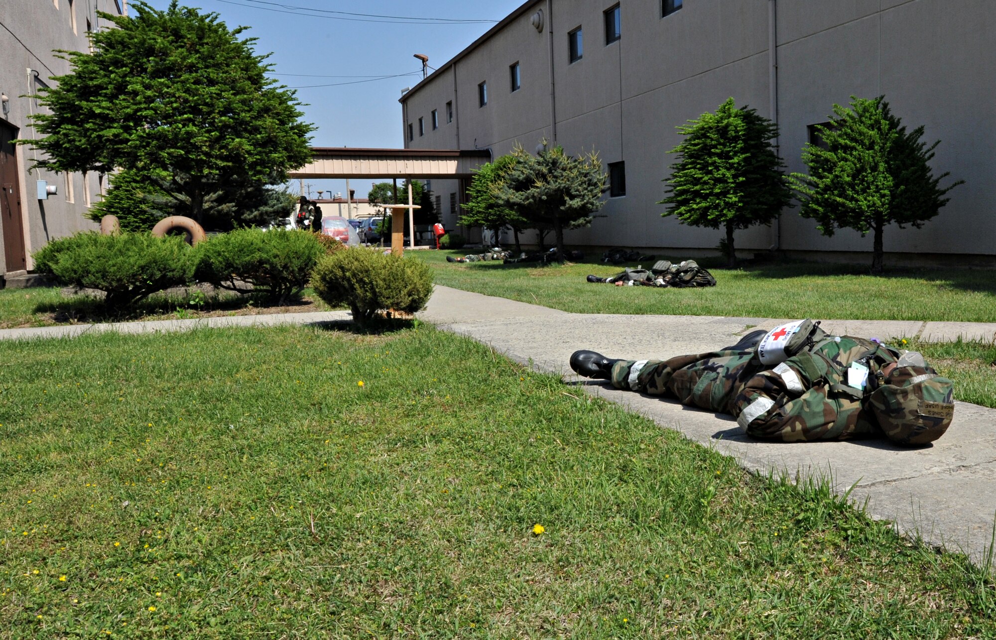 Airmen acting as casualties lie in wait for post-attack reconnaissance teams during Operational Readiness Exercise Beverly Bulldog 14-02 at Osan Air Base, Republic of Korea, May 6, 2014. Multiple attacks on Bldg. 938 and a mock structure fire produced roughly one dozen simulated dead and injured personnel. (U.S. Air Force photo/Airman 1st Class Ashley J. Thum)