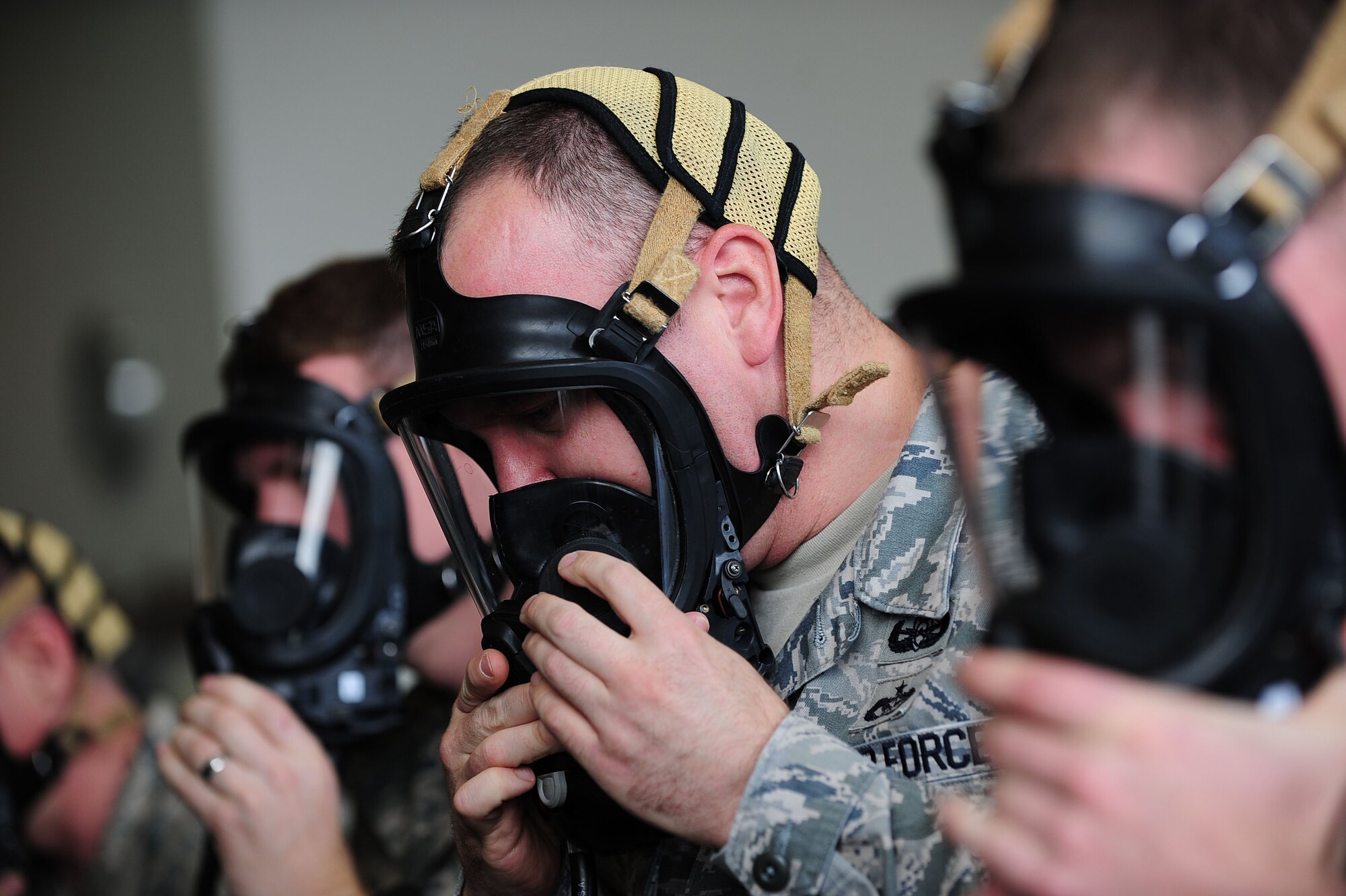 Staff Sgt. James Hardcastle 39th Civil Engineer Squadron explosive ordnance disposal technician, dons a self contained breathing apparatus mask during a readiness inspection May 2, 2014, Incirlik Air Base, Turkey.  EOD along with many other units at Incirlik AB, were inspected by the United States Air Forces in Europe inspector general team. (U.S. Air Force photo by Senior Airman Nicole Sikorski/Released)
