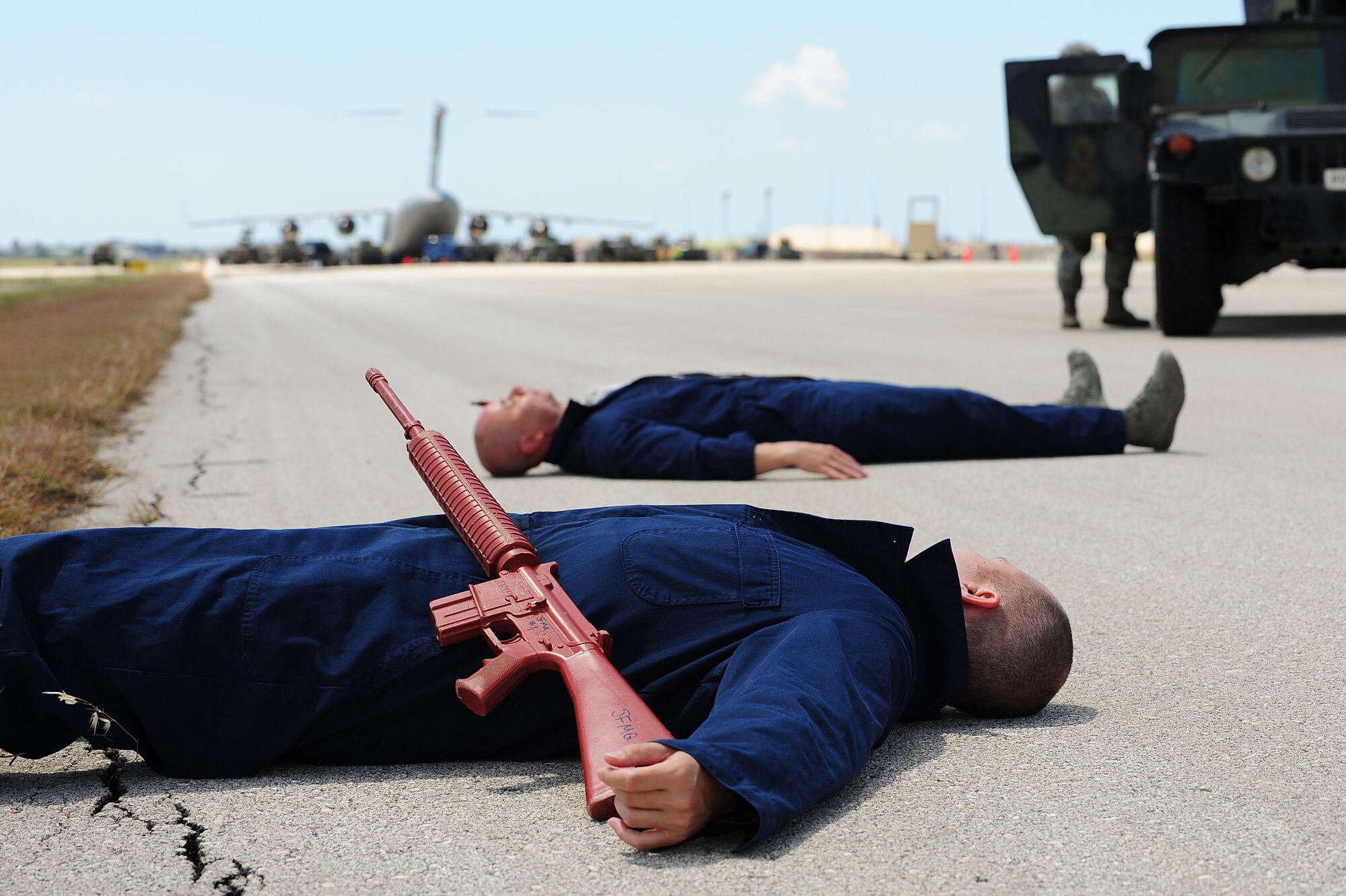 Master Sgt. Meza Santos and Tech. Sgt. Jonel Relojo, both United States Air Forces in Europe inspector general team members, lay on the ground after a simulated ground attack May 1, 2014, Incirlik Air Base, Turkey.  The USAFE IG team visited Incirlik AB to conduct a readiness inspection of the 39th Air Base Wing.  (U.S. Air Force photo by Senior Airman Nicole Sikorski/Released)