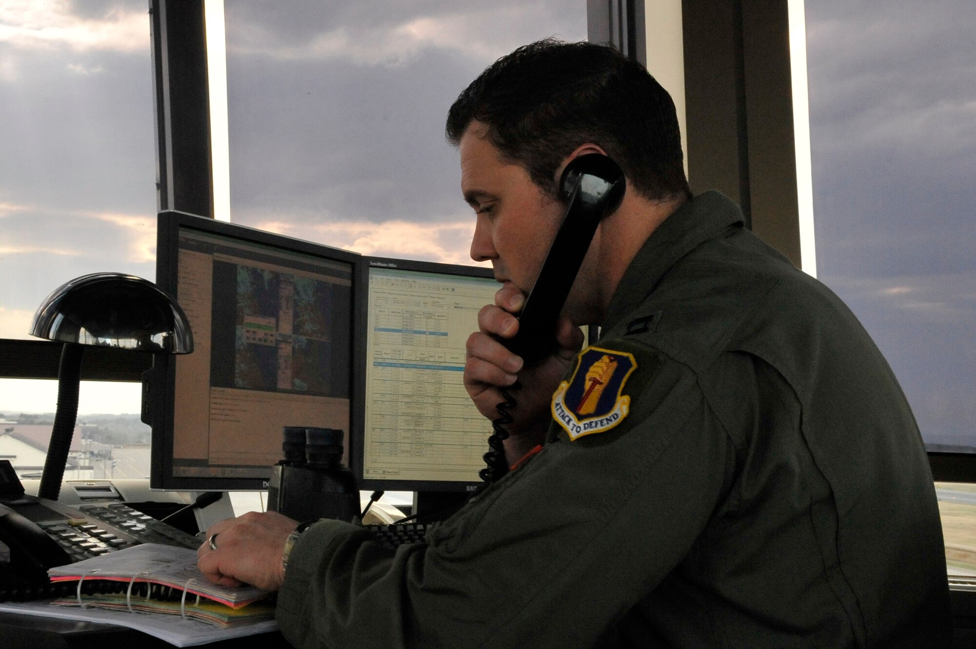 U.S. Air Force Capt. Christian Hamilton, 35th Operations Support Squadron aircrew flight equipment flight commander and supervisor of flight, speaks to a pilot on his radio frequency while consulting his safety checklist. During an in-flight emergency, the SOF will reference his safety checklist, contact agencies like Base Operations and the Fire Department and communicate with pilots, to coordinate a safe landing for the aircraft in distress. (U.S. Air Force photo/Airman 1st Class Patrick S. Ciccarone)