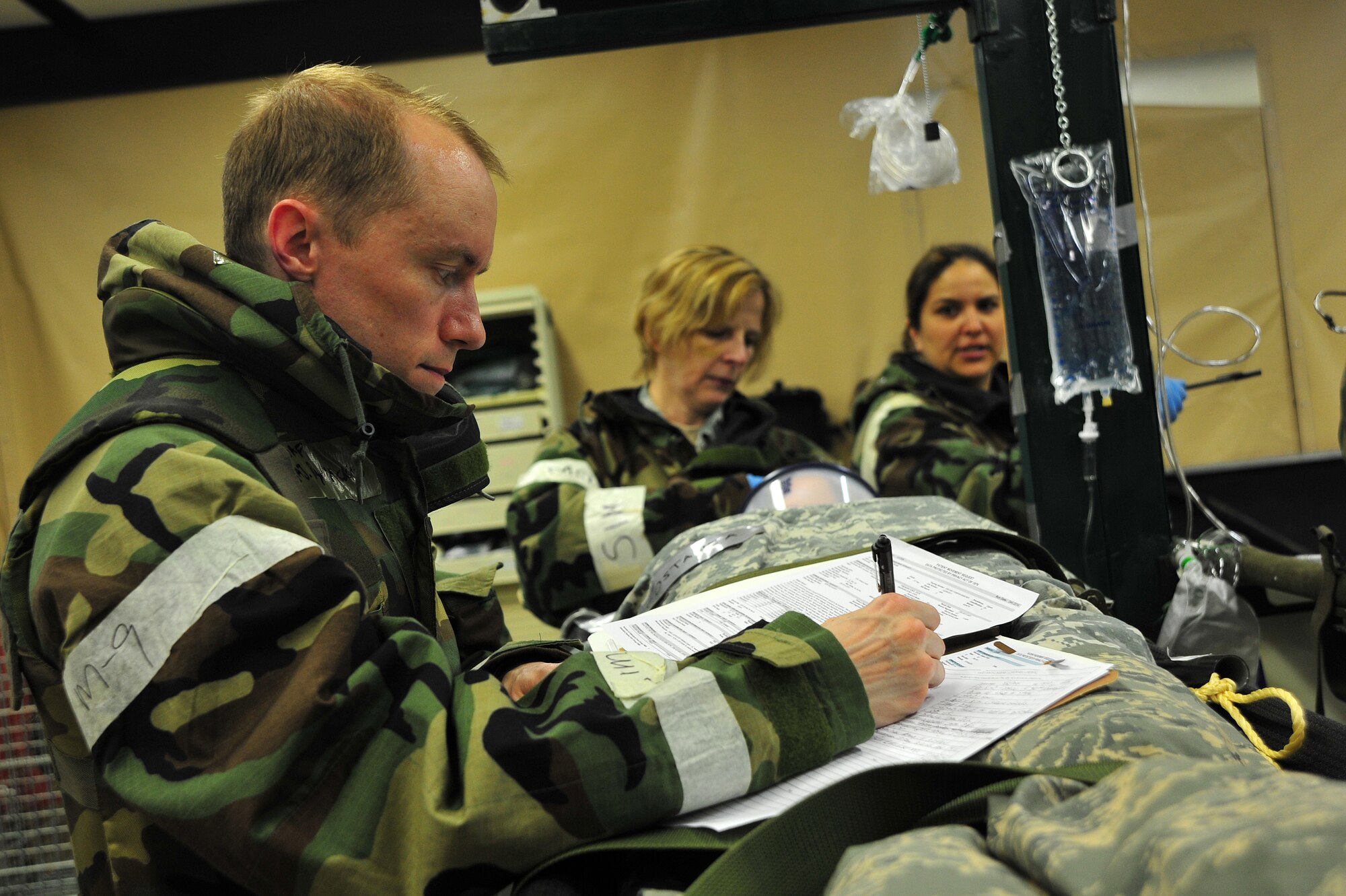 U.S. Air Force Maj. Ryan Hackett, 35th Medical Operations Squadron family practice physician, documents the medical condition of a simulated patient during an Operational Readiness Exercise at Misawa Air Base, Japan, May 5, 2014. Hackett’s patient was injured in an improvised explosive device attack, suffered a jaw laceration and lost some teeth. Hackett said in a real-world scenario, he would work to prevent infection and control pain. (U.S. Air Force photo/Senior Airman Jose L. Hernandez-Domitilo)