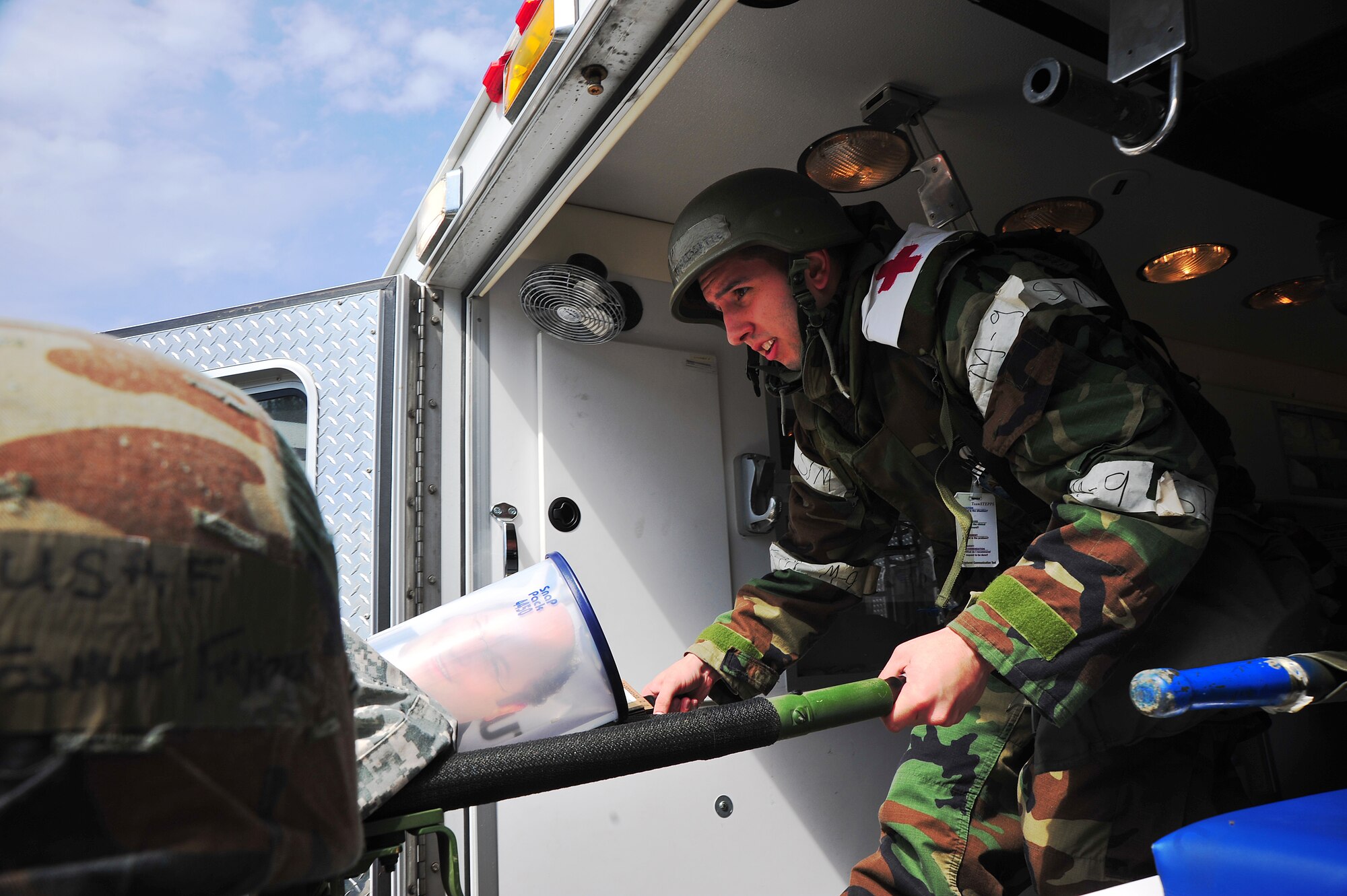 U.S. Air Force Staff Sgt. Ryan Morrissette, 35th Medical Support Squadron air evacuation clerk, moves a simulated patient onto a medical transport vehicle during an Operational Readiness Exercise at Misawa Air Base, Japan, May 5, 2014. This is part of a mass casualty exercise requiring transport of numerous patients. After evacuation, the medical staff provided patients specialists to tend to injuries. (U.S. Air Force photo/Senior Airman Jose L. Hernandez-Domitilo)