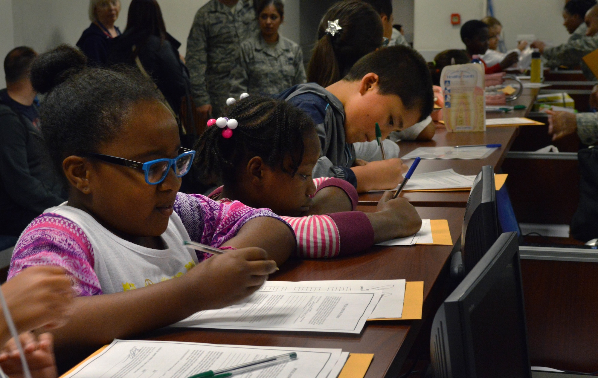 Aviano Elementary School students go through a Military Personnel Flight processing line during a mock deployment, May 2, 2014, at Aviano Air Base, Italy. The mock deployment showed students various procedures their parents could potentially go through when preparing for a deployment. (U.S. Air Force photo/Senior Airman Kristine MacDonald)