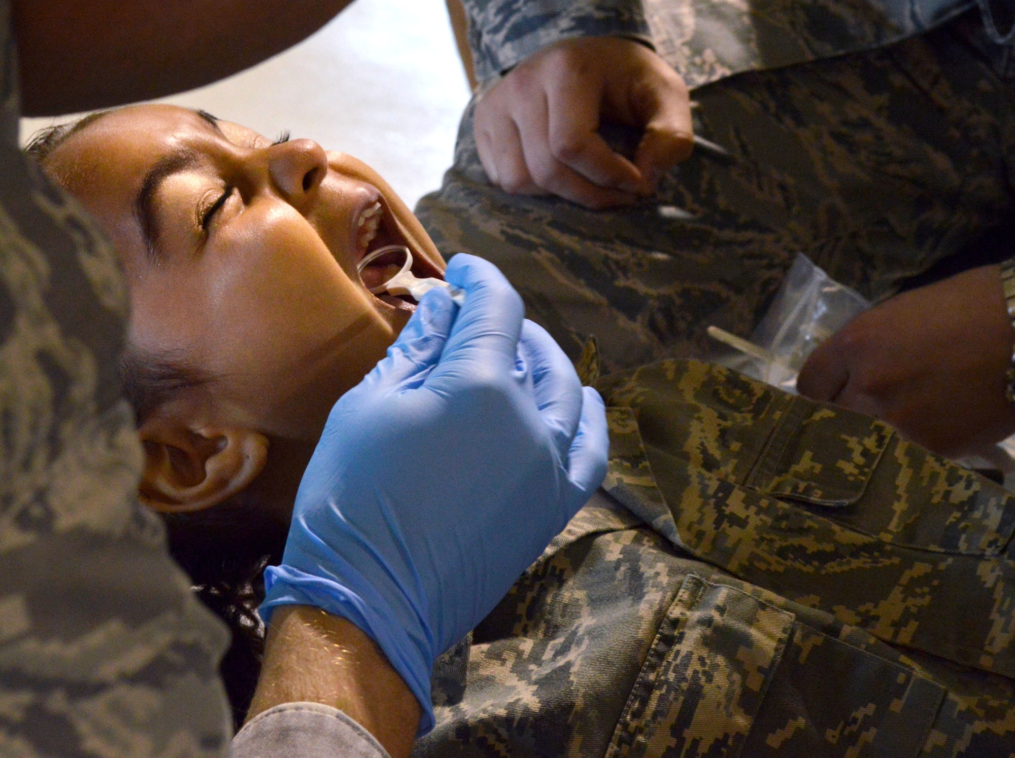 Kiyah Morris, Aviano Elementary School kindergartner, receives a dental checkup during a mock deployment, May 2, 2014, at Aviano Air Base, Italy. The mock deployment showed students various procedures their parents could potentially go through when preparing for a deployment. (U.S. Air Force photo/Senior Airman Kristine MacDonald) 