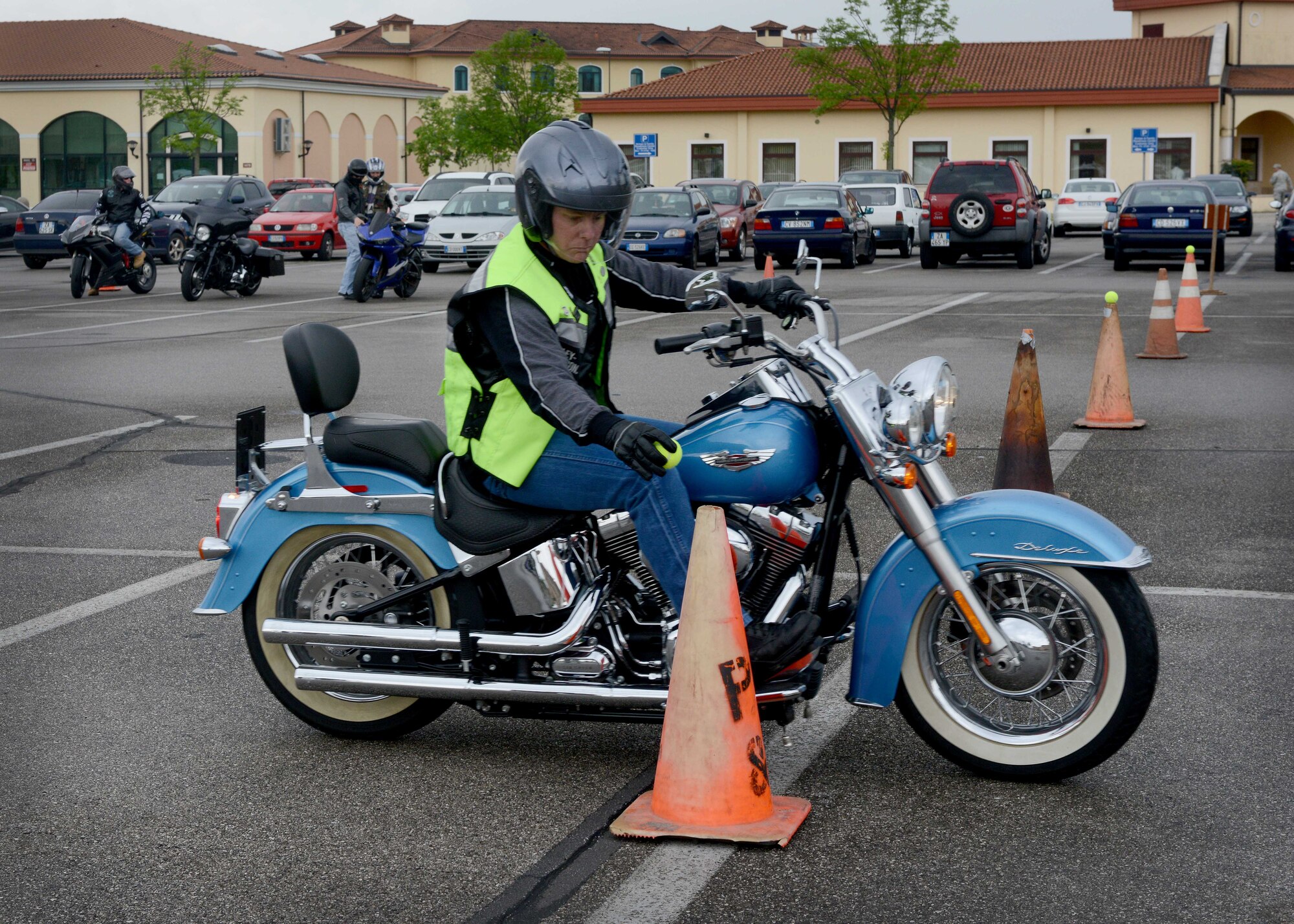 Chief Master Sgt. Brian Gates, 31st Mission Support Squadron superintendent, places a tennis ball on a cone during the motorcycle rodeo, May 2, 2014, at Aviano Air Base, Italy. This event tests riders clutch control in a small and safe environment, which allows riders to fulfill an annual safety requirement.  Each year, base motorcyclists review seasonal hazards, regulations, local motorcycle clubs and general safety tips.  (U.S. Air Force photo/Airman 1st Class Abbey Whittaker)