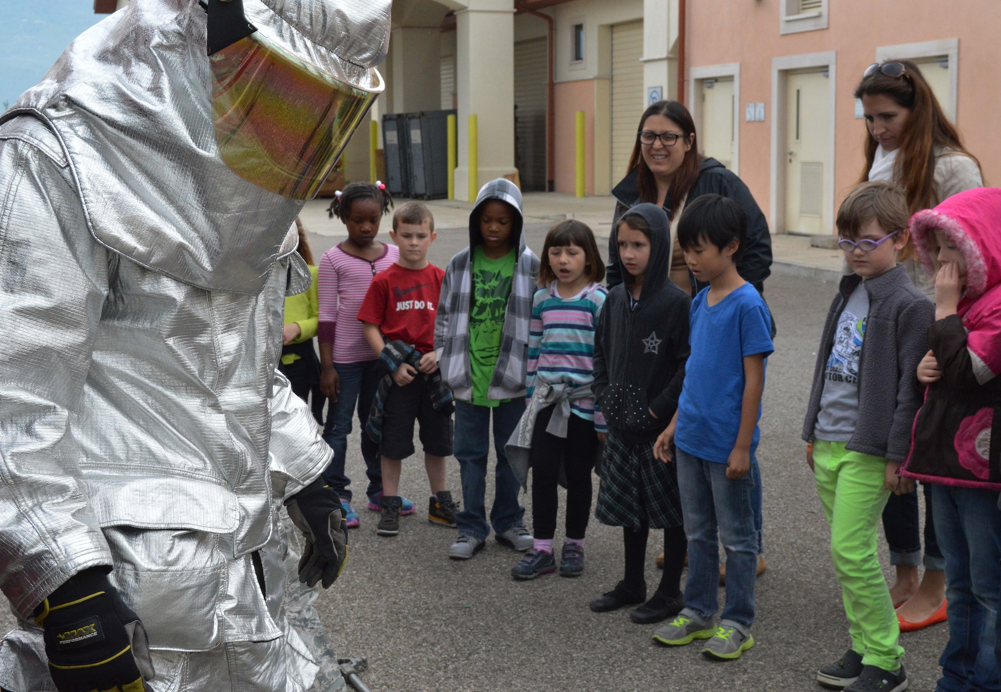 Aviano Elementary School children watch as firefighters from the 31st Civil Engineer Squadron explain special firefighting equipment, May 2, 2014, at Aviano Air Base, Italy. The demonstration was a part of a mock deployment line, designed to teach children what it’s like to deploy.  During the demonstration, firefighters displayed different techniques and equipment used to combat fires in various environments.  (U.S. Air Force photo/Senior Airman Kristine MacDonald)