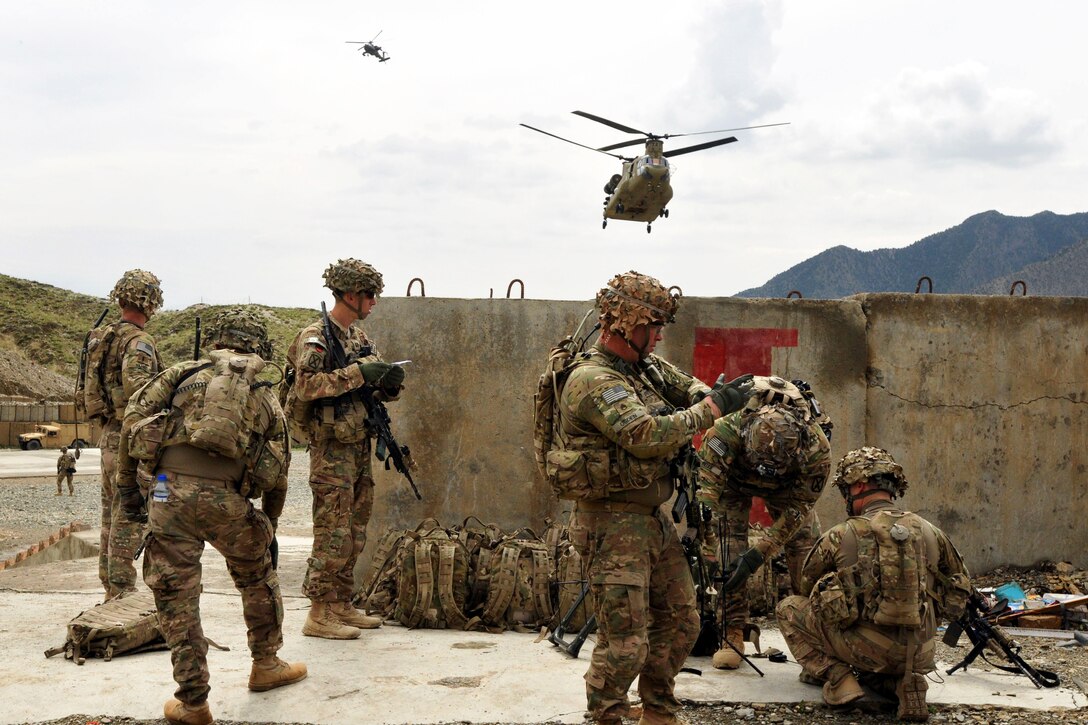 U.S. Army Capt. James Guglielmi, third from left, and U.S. Army Staff Sgt. Dale Ogden, foreground, direct their soldiers as they set up their command post to provide security for a joint U.S. and Afghan forces security meeting in the Chamkani district of Afghanistan's Paktia province, May 4, 2014. Guglielmi is commander of the 10th Mountain Division's 3rd Squadron, 71st Cavalry Regiment, 3rd Brigade Combat Team, and Ogden is a platoon sergeant.