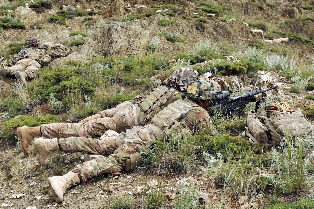 U.S. soldiers man an over watch fighting position during their mission ...