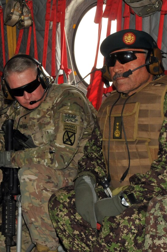 U.S. Army Brig. Gen. David Haight, left, talks with Afghan army Maj. Gen. Mohammad Yaftali aboard a CH-47 Chinook helicopter after the conclusion of a joint U.S. and Afghan forces security meeting in the Chamkani district of Afghanistan's Paktia province, May 4, 2014. Haight is assigned to the 10th Mountain Division, and Yaftali is commander of the 203rd Corp.