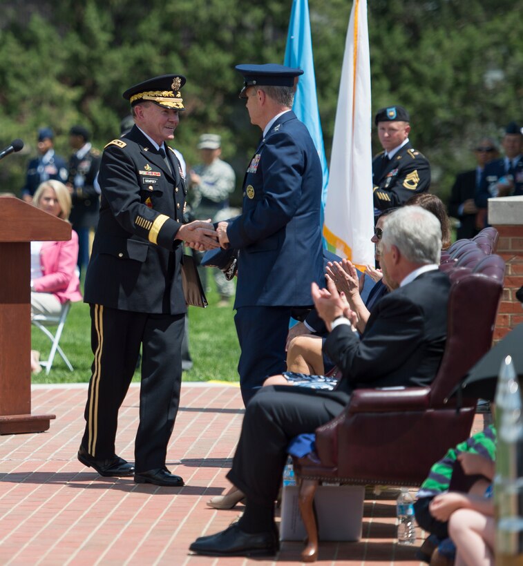 Army Gen. Martin E. Dempsey, chairman of the Joint Chiefs of Staff, shakes hands with Air Force Gen. Paul J. Selva, the incoming commander of U.S. Transportation Command, at the change-of-command ceremony on Scott Air Force Base, Ill., May 5, 2014. 