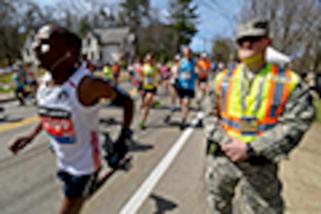 Army Spc. Brandon Smith provides security at the start of the 2014 Boston Marathon in Hopkinton, Mass., April 21, 2014. About 800 Massachusetts National Guardsmen assisted local authorities to ensure the event would be as safe as realistically possible. Due to a record number of runners, Guardsmen from numerous states augmented the Massachusetts Guard's specialized units. Smith is assigned to the Rhode Island Army National Guard's 169th Military Police Company. 