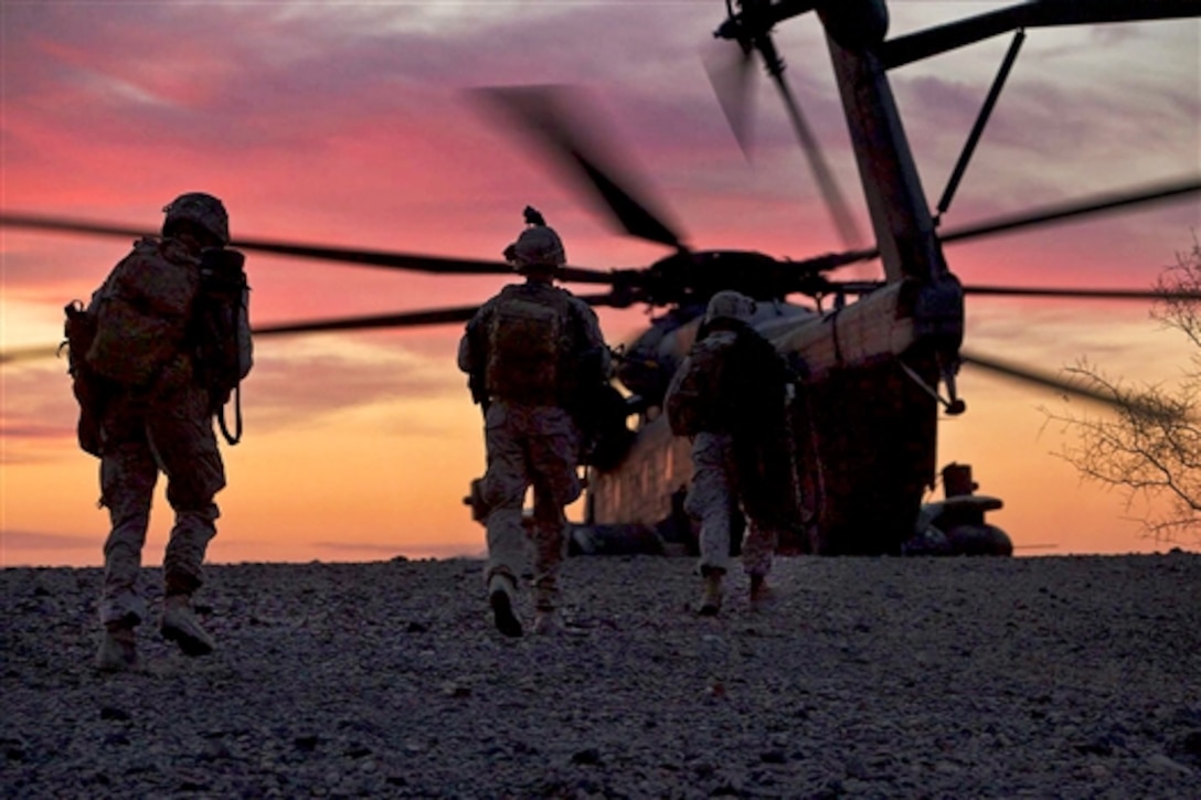 Marines board a helicopter after helicopter raid training as part of a weapons and tactics course for instructors on Yuma Proving Ground, Ariz., April 9, 2014. The training teaches the basics of Marine Corps aviation and provides strategy, tactics and execution experience. The Marines are assigned to 2nd Marine Division's India Company, 3rd Battalion, 6th Marine Regiment.  