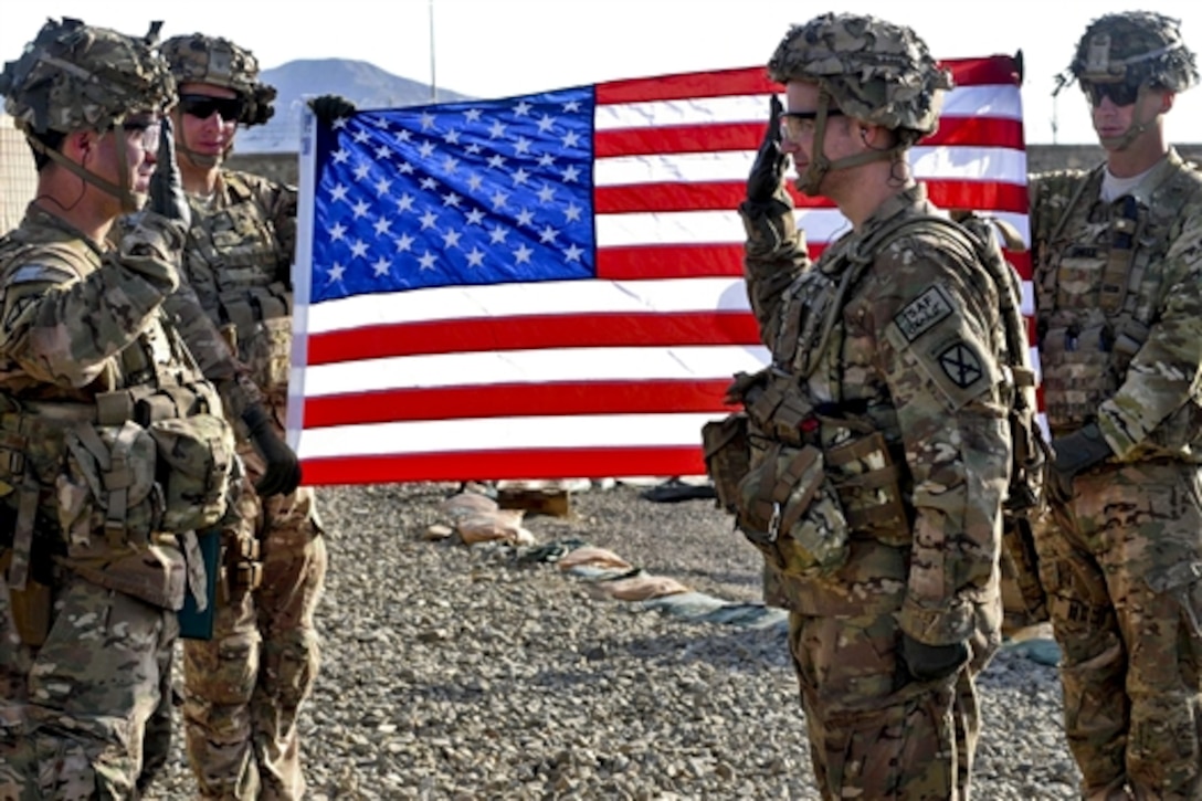 U.S. Army 1st Lt. Brian Godwin administers the oath of enlistment to U.S. Army Sgt. Jonathan Conover during a ceremony on Forward Operating Base Lightning in Afghanistan's Paktia province, April 27, 2014. Goodwin and Conover are assigned to the 10th Mountain Division's 4th Battalion, 25th Field Artillery Regiment, 3rd Brigade Combat Team.  