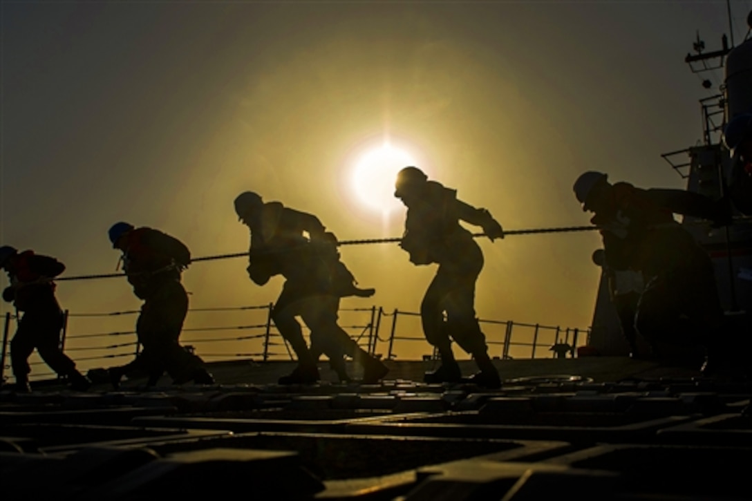 U.S. sailors heave a line during a replenishment with the Military Sealift Command dry cargo and ammunition ship USNS Robert E. Peary aboard the guided-missile destroyer USS Roosevelt in the Arabian Sea, April 25, 2014. The Roosevelt is supporting maritime security operations and theater security cooperation efforts in the U.S. 5th fleet area of responsibility.  