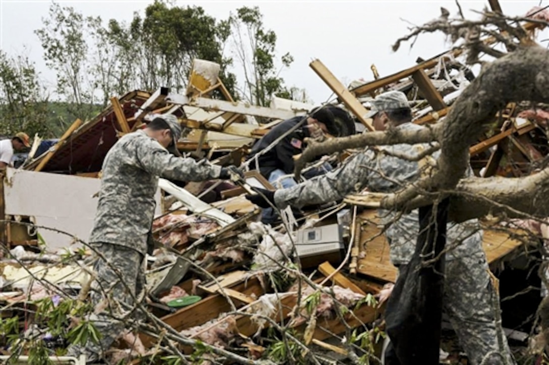 Arkansas Guardsmen assist a family with salvaging precious heirlooms from the debris in Mayflower, Ark., April 28, 2014, following a deadly tornado that struck small communities April 27 in the center of the state. The soldiers are assigned to Special Troops Battalion, 39th Infantry Brigade Combat Team, Arkansas National Guard.  