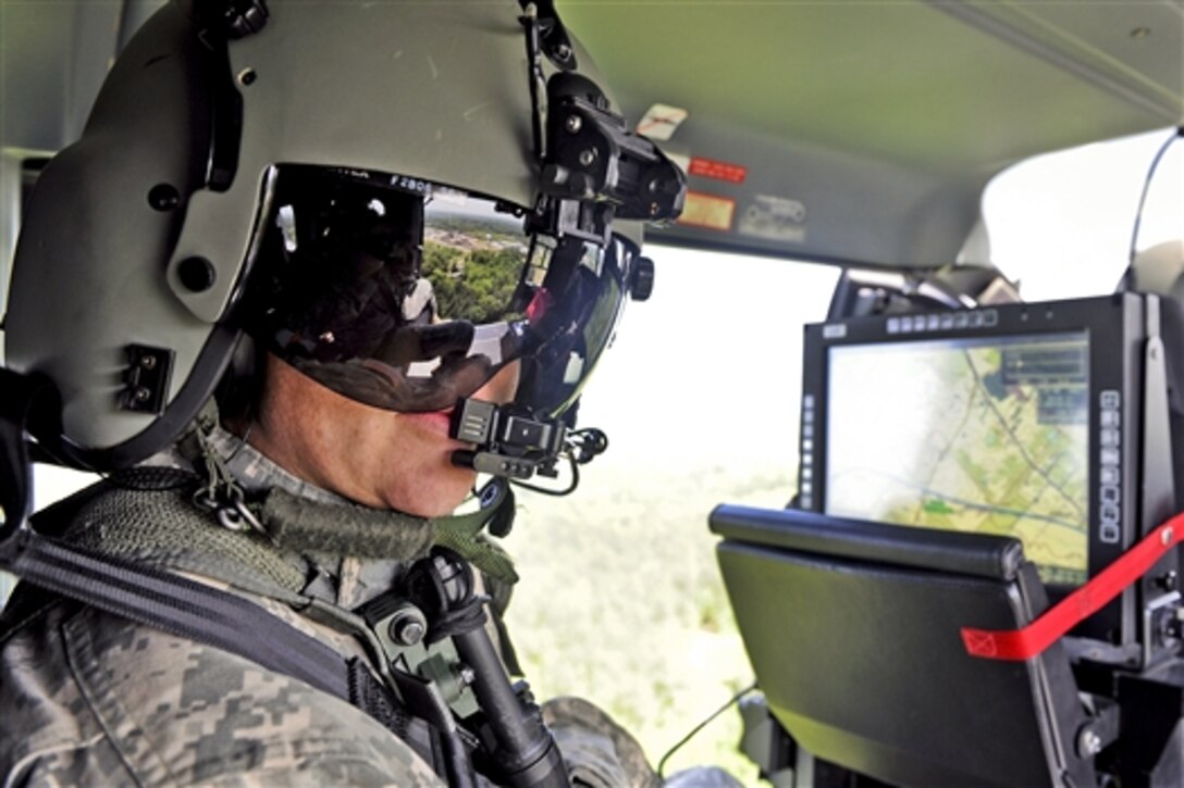 Army Staff Sgt. Trey Wise observes tornado damage in Louisville, Miss., April 29, 2014, aboard a Mississippi Army National Guard LUH-72 Lakota helicopter. About 50 Mississippi Guardsmen responded to help, performing a variety of missions, including traffic control, patrolling and assisting local law enforcement officers.  