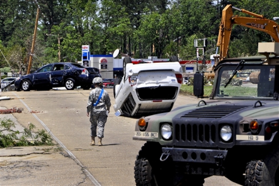 A Mississippi Guardsman surveys damage on several streets in Tupelo, Miss., April 29, 2014. About 50 Mississippi Guardsmen responded to help, performing a variety of missions, including traffic control, patrolling and assisting local law enforcement officers.  