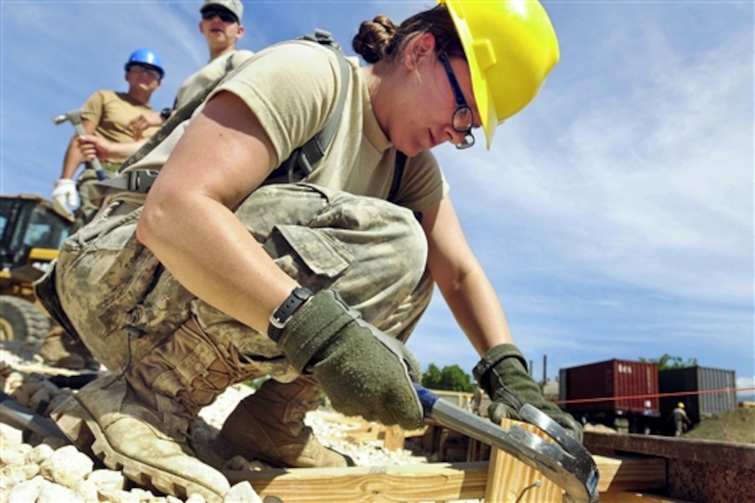 A U.S. service member reinforces the supporting planks before pouring slurry for the foundation for a new school during Beyond the Horizon 2014 in Barahona, Dominican Republic, April 21, 2014. The mission provides humanitarian aid assistance to Latin American countries to improve quality of life for residents. The service members are assigned to Task Force Larimar. 