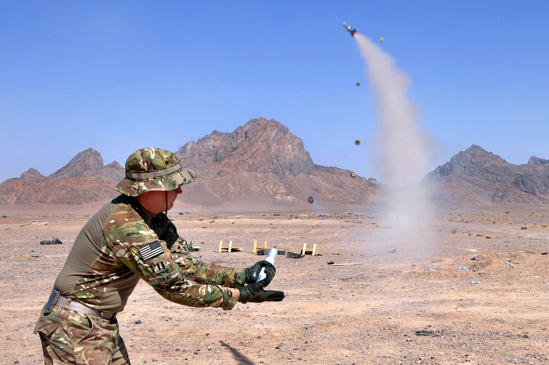 U.S. Navy Lt. Chad Dulac actuates a parachute signal flare during weapons and explosives training at the range on Forward Operating Base Farah, Afghanistan, Sept. 20, 2013. Dulac, a public affairs officer, is assigned to Provincial Reconstruction Team Farah.  
