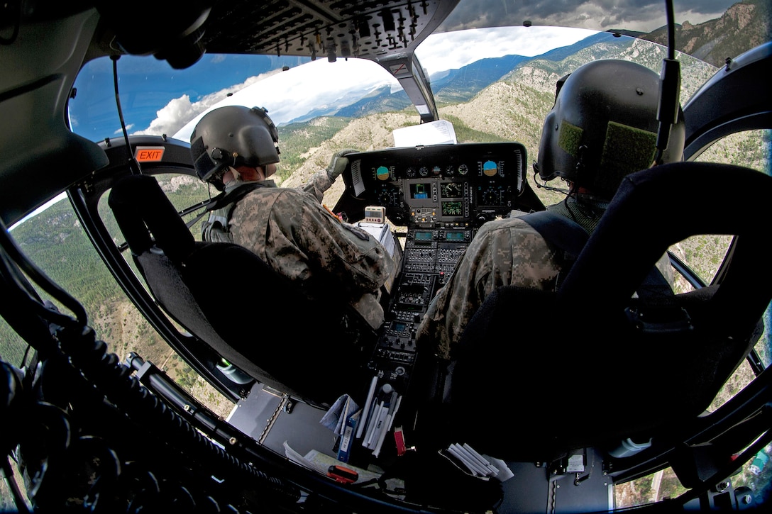 Army Chief Warrant Officers 4 Mike Eger and Troy Parmley fly a UH-72 Lakota helicopter over flooded areas as part of relief and recovery operations near Fort Collins, Colo., Sept. 18, 2013. Eager, a pilot, is assigned to the Colorado Army National Guard's 2nd Battalion, 135th Aviation Regiment, and Parmley, a pilot, is assigned to the Colorado Army National Guard's Company D, 3rd Battalion, 148th Aviation Regiment.  
